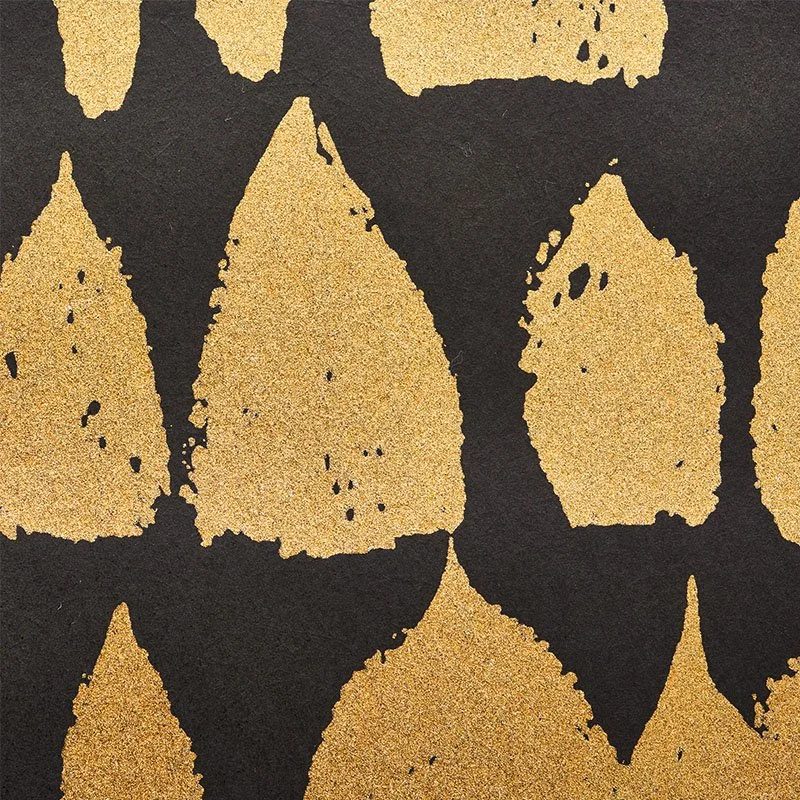 Close view of Schumacher Queen of Spain in Gold, metallic gold shapes on a black ground
