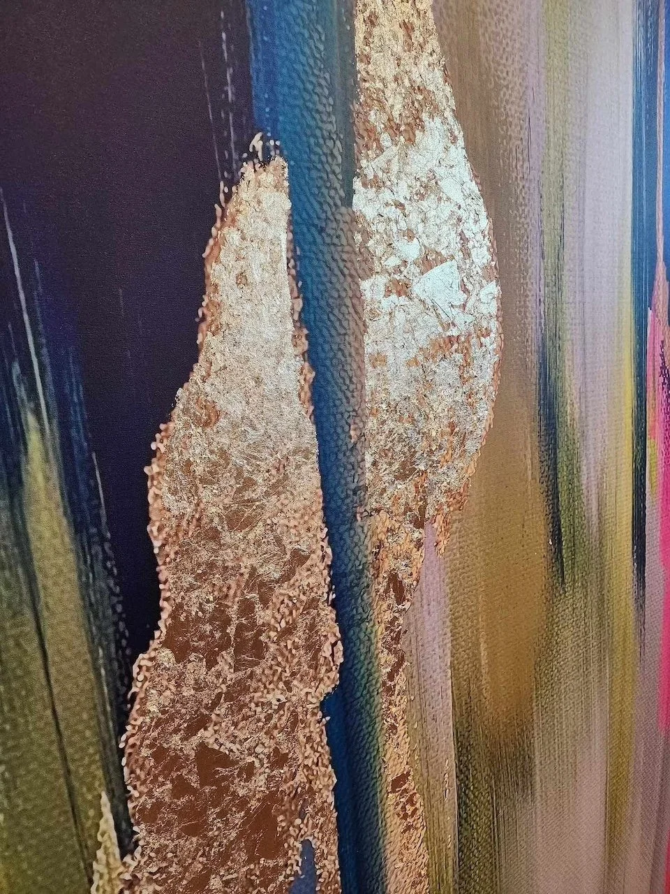 Abstract painting with gold leaf accents and vertical strokes in blue, green, and brown tones on a textured canvas.