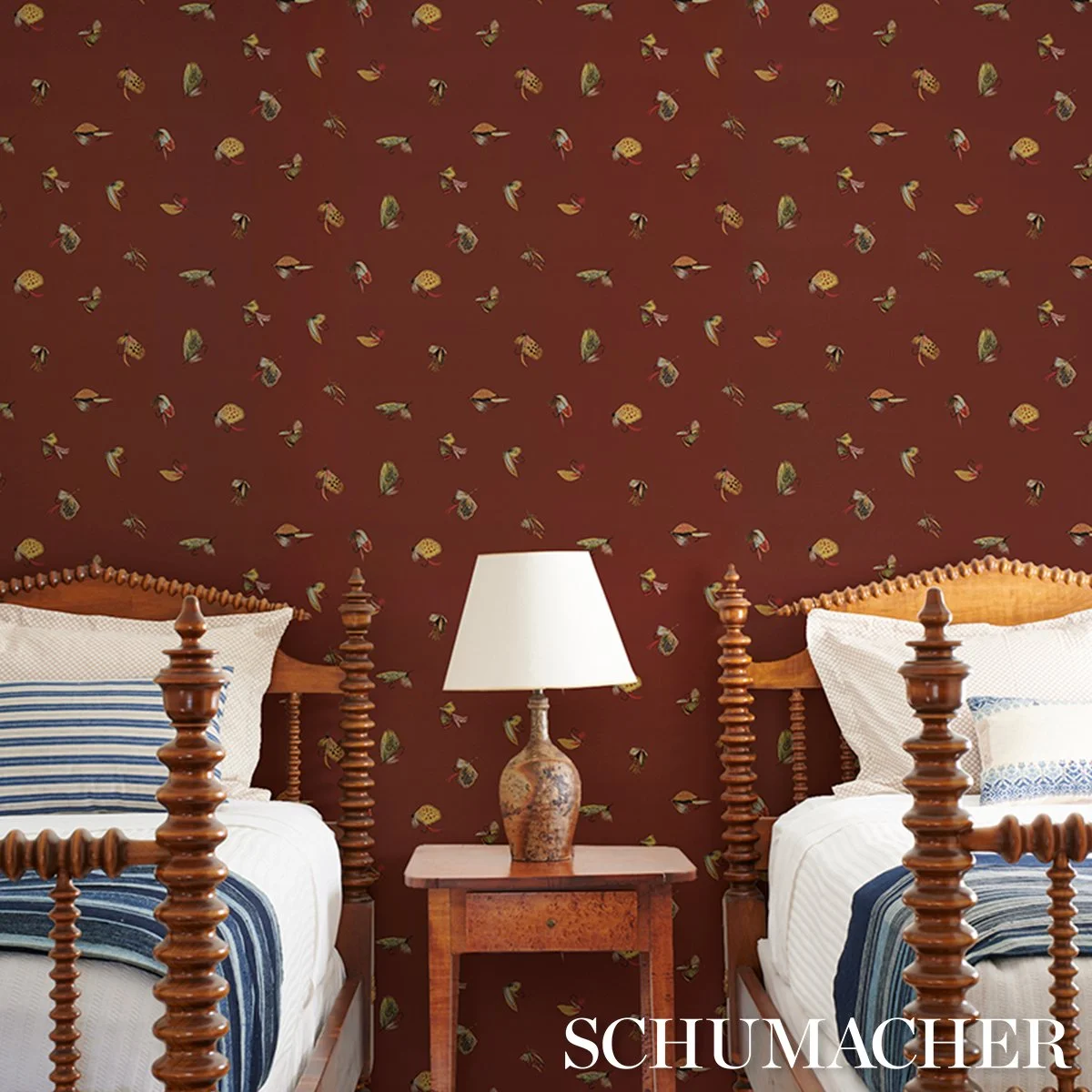 Schumacher Fly Fishing Russet wallpaper in a guest bedroom with twin spindle beds, a wood side table, and a cream lamp