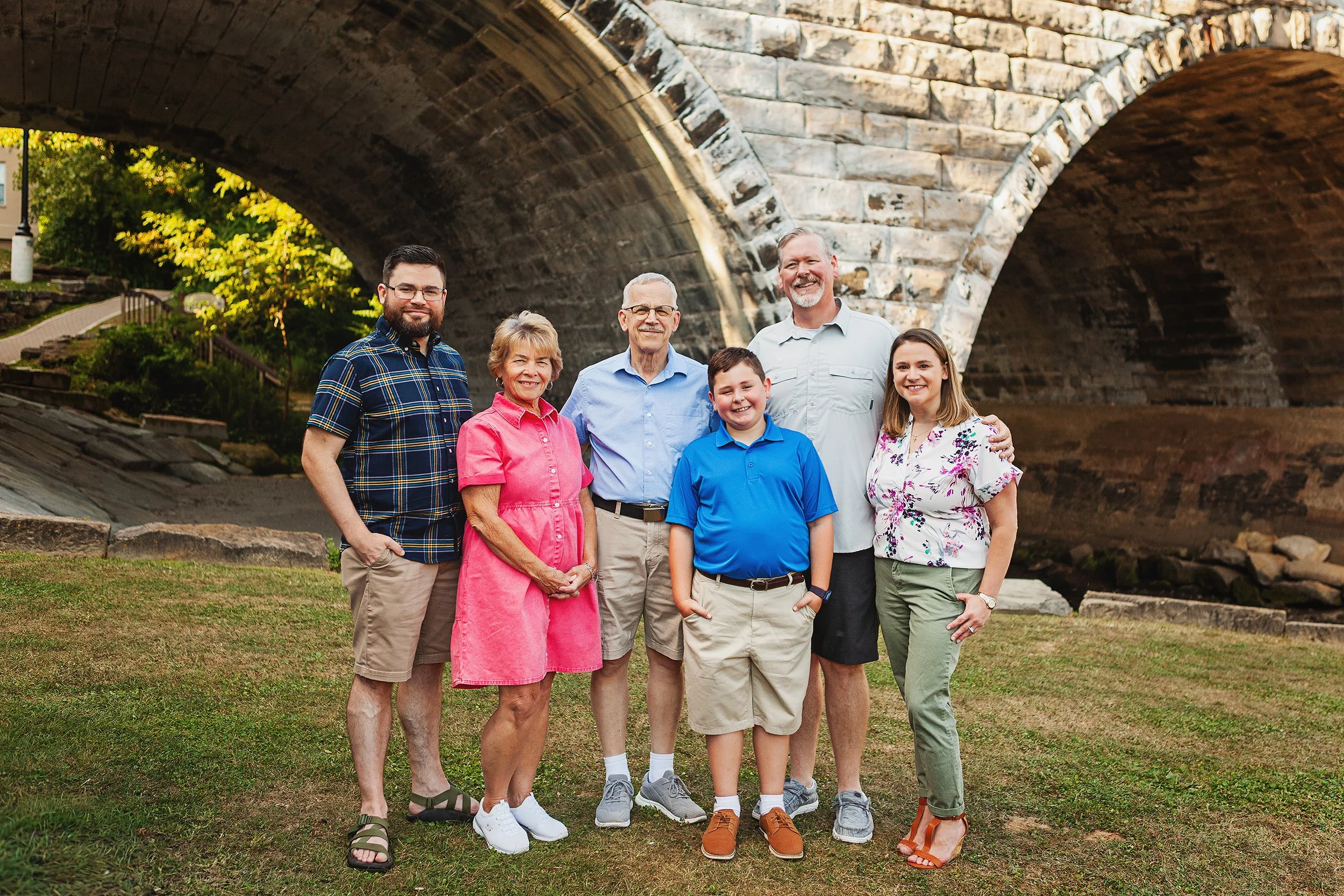 Grandparents and children in front of Main Street bridge in downtown Kent with stone bridge arches