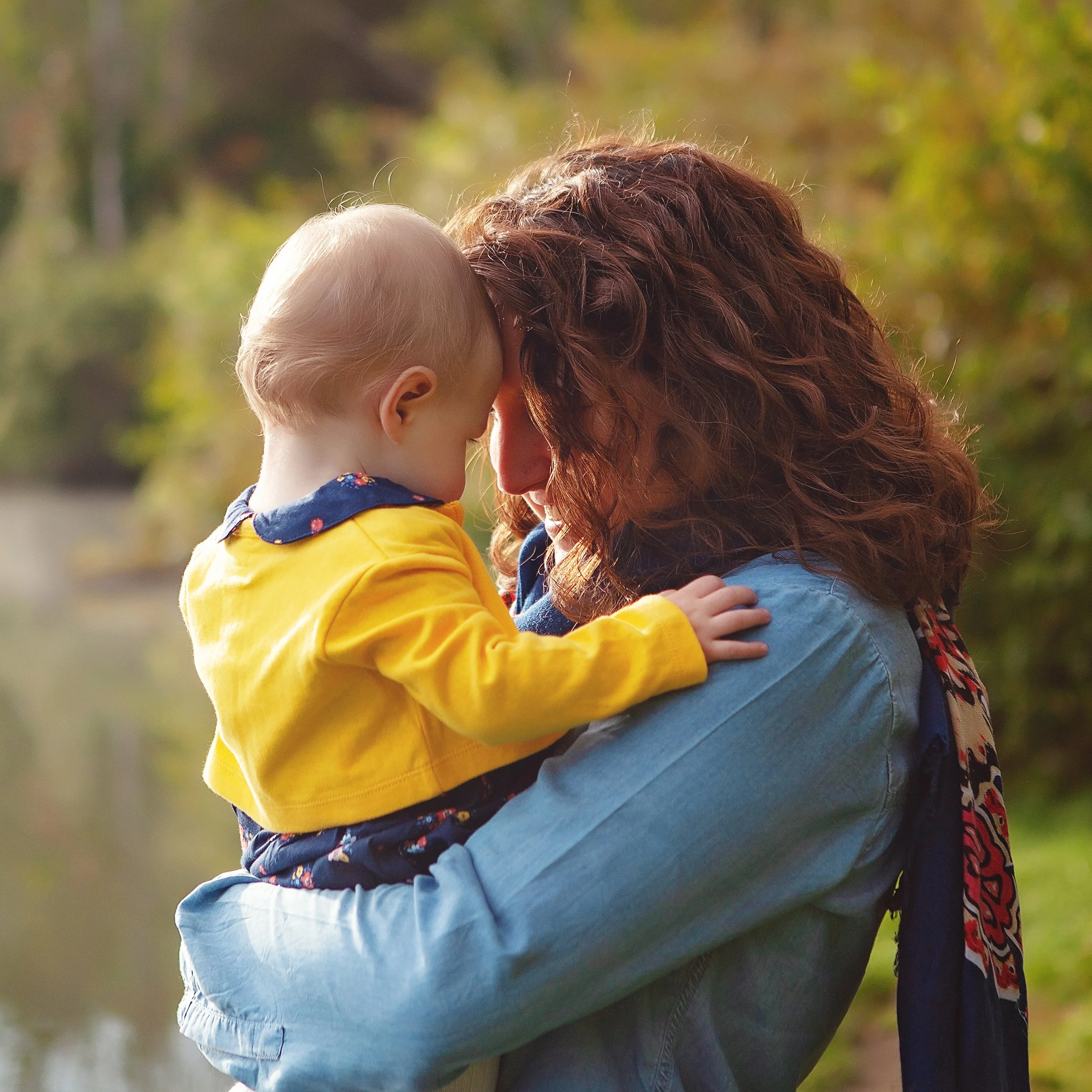 A mother and baby touching foreheads and smiling in hudson ohio portrait session