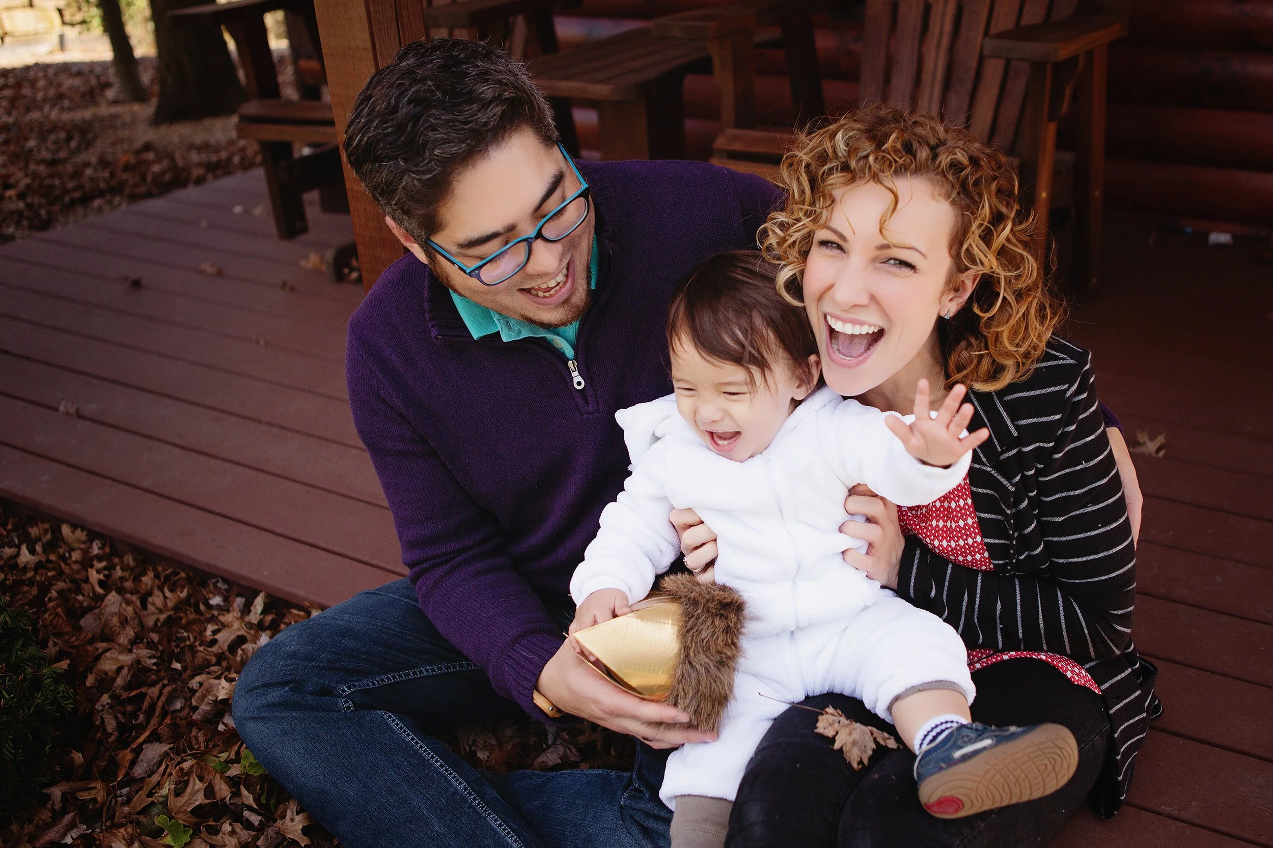 Happy family portrait at their home in Cleveland Ohio, mom and dad sitting with excited boy in Where the Wild Things Are costume, max with crown