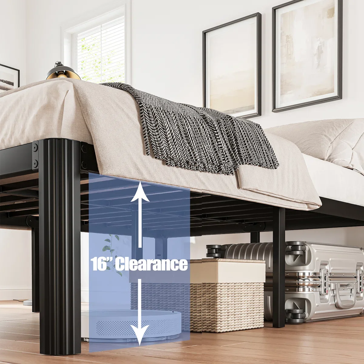 Under the bed with a 16-inch clearance, there is a portable speaker, a stack of storage boxes, and a metal suitcase. The bed has beige bedding, a black and white throw blanket, and is in a room with a window and framed artwork above.