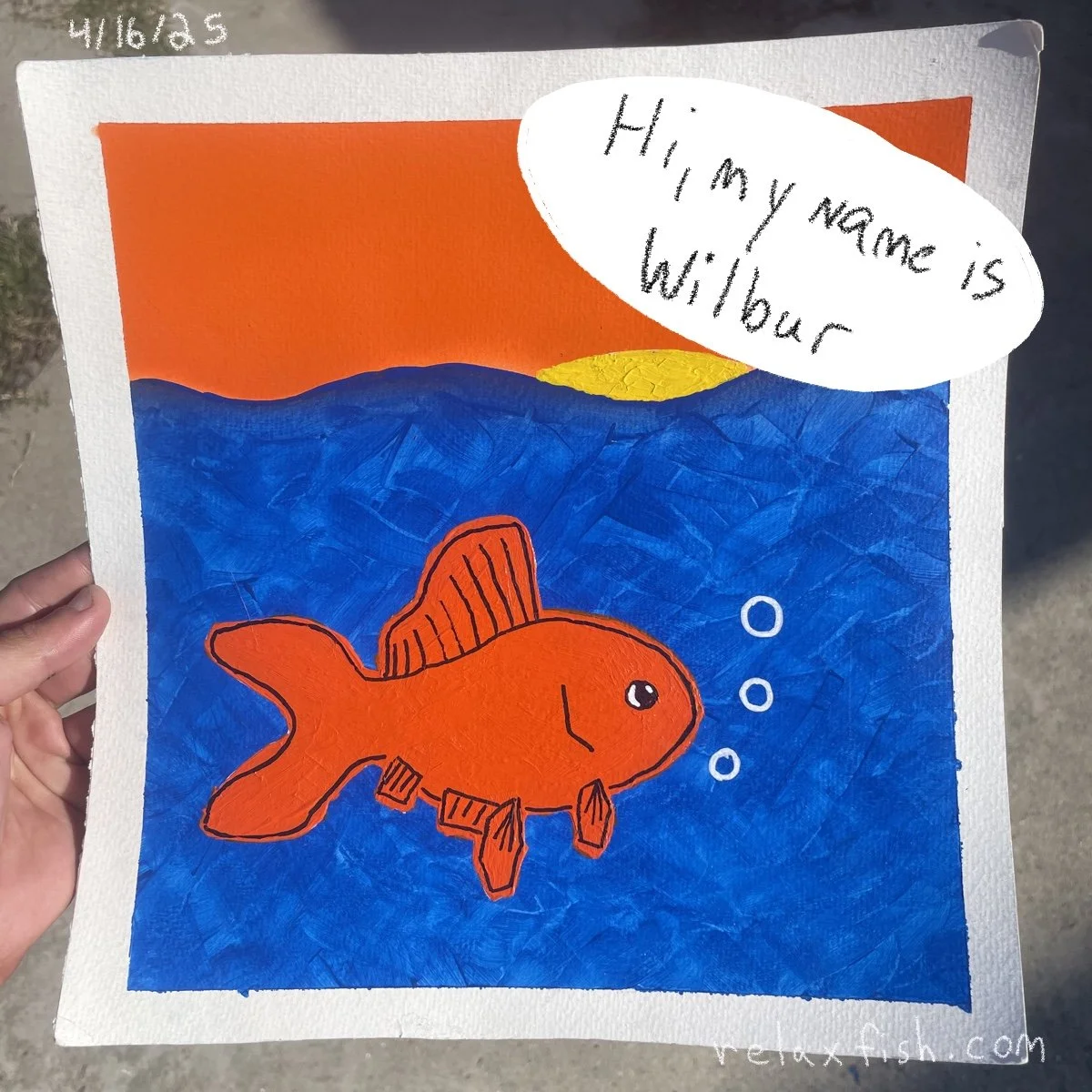 Child's colorful drawing of an orange fish swimming in blue water with a sunset or sunrise in the background, and a speech bubble saying "Hi, my name is Wilbur".