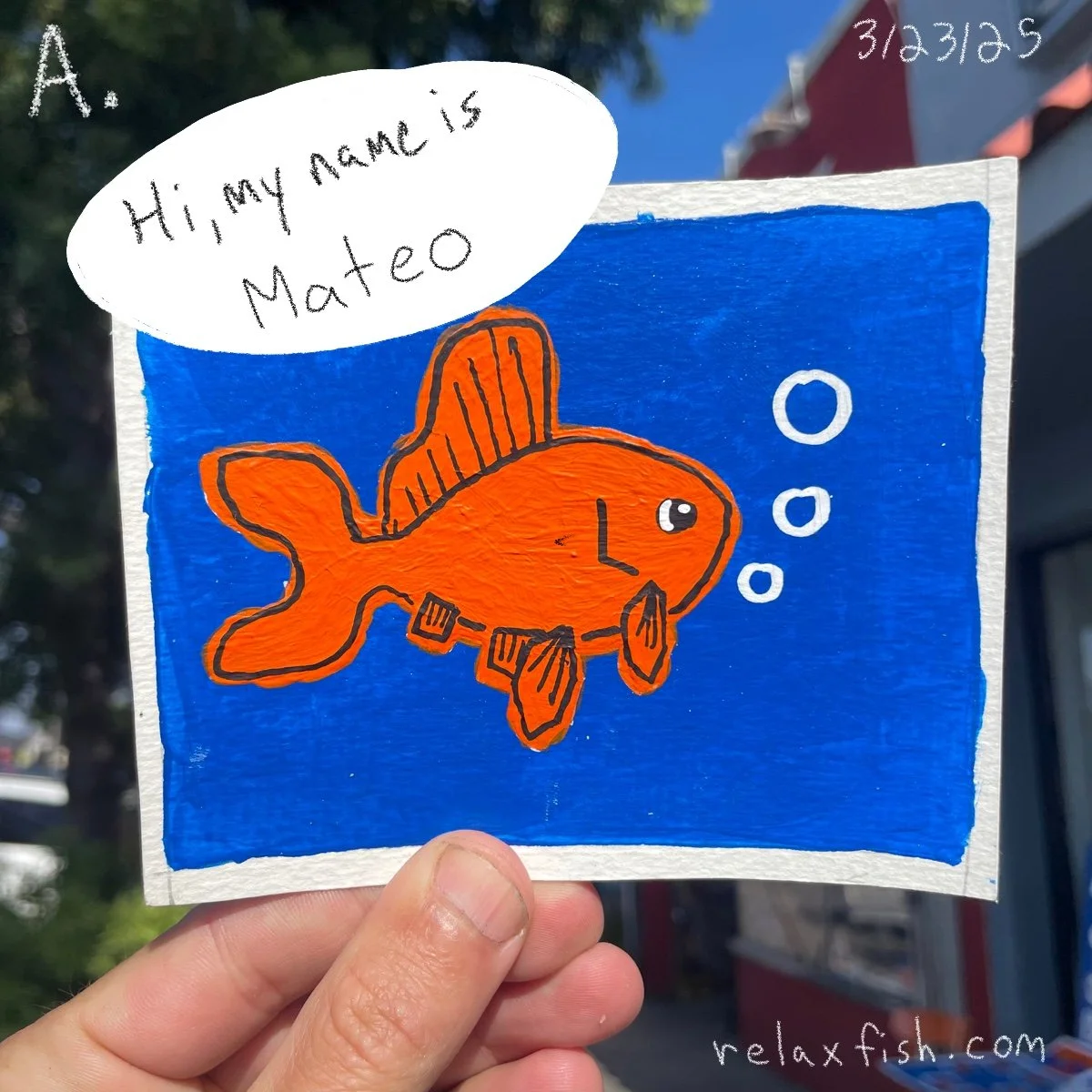Handmade drawing of a smiling orange fish with fins and tail, wearing glasses, against a blue background. A speech bubble says, 'Hi, my name is Mateo.' The top right corner has the date, 3/31/25, and the bottom right corner has a website, relaxfish.c
