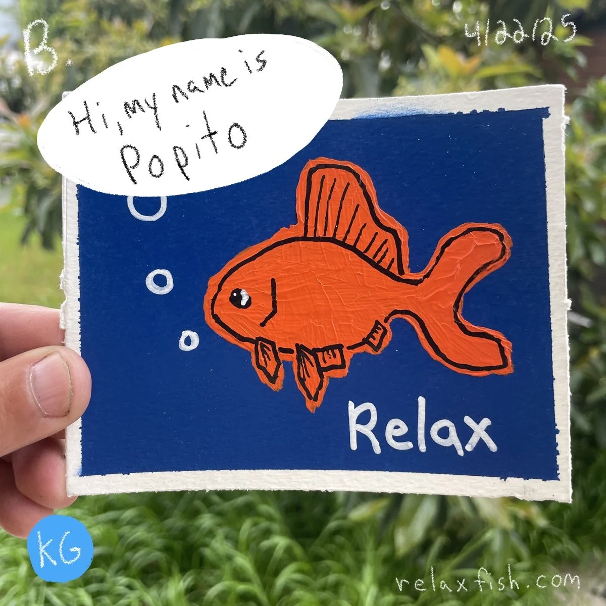 Colorful drawing of an orange fish with black outlines, bubbles, and the word 'Relax' on a blue background, held in a person's hand against greenery, with a speech bubble saying "Hi, my name is Popito."