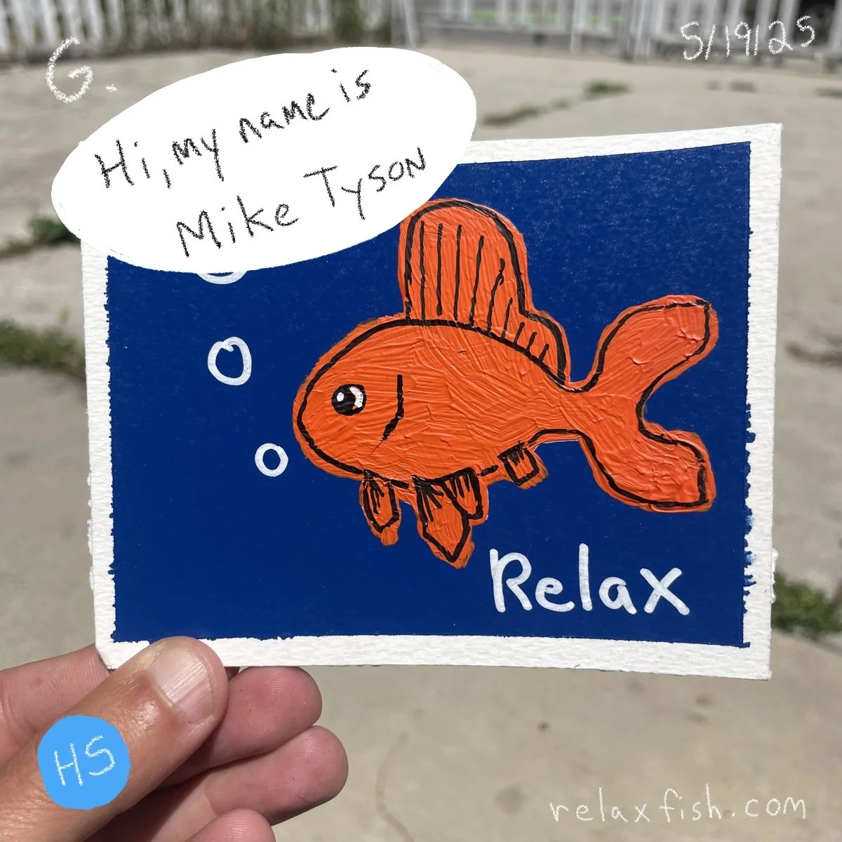 A hand holding a watercolor drawing of an orange fish with black outlines on a blue background. The fish is blowing bubbles and has a speech bubble that says, 'Hi, my name is Mike Tyson.' The words 'Relax' and the website 'relaxfish.com' are also vis