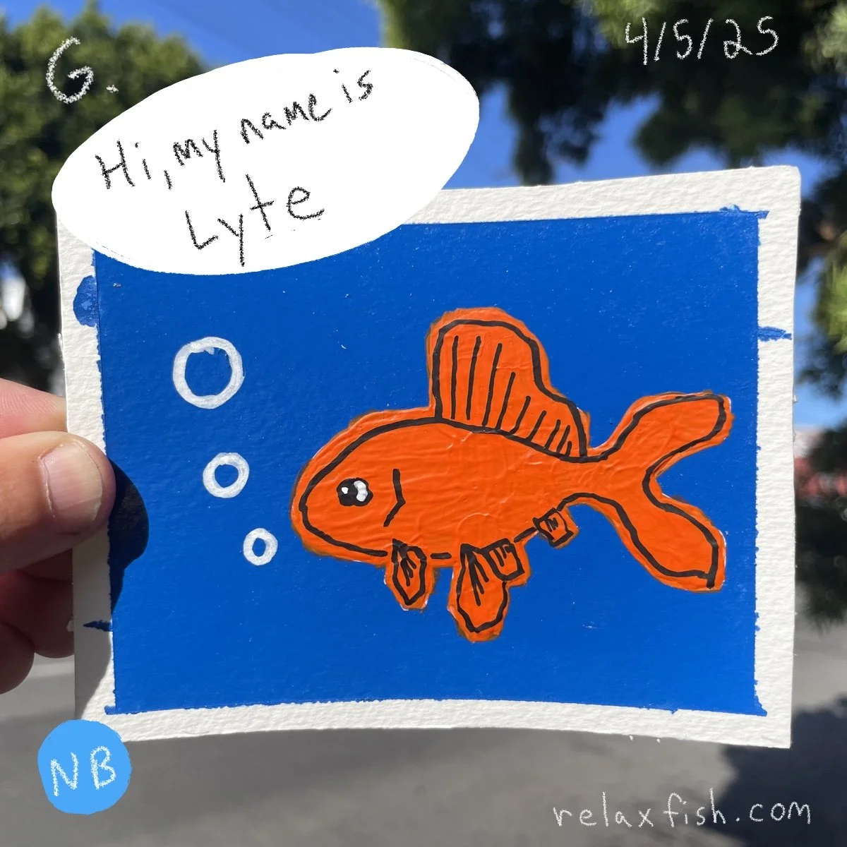 A colorful drawing of an orange fish with black outlining against a blue background. The fish has a big eye, fins, and a small mouth with black markings. There are three bubbles near the fish. A speech bubble in the top left corner says, "Hi, my name