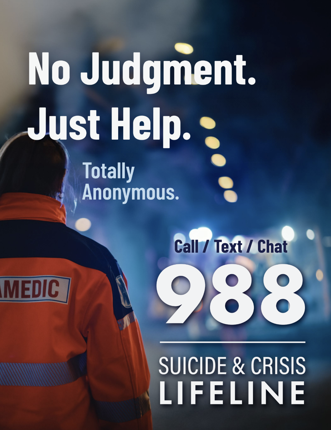 A person in an orange paramedic uniform standing on a city street at night with the text "No Judgment. Just Help. Totally Anonymous. Call / Text / Chat 988 Suicide & Crisis Lifeline" overlaid.