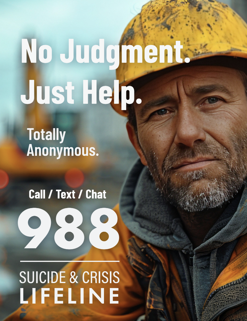 A man wearing a yellow safety helmet and orange work jacket, with a serious expression, standing outdoors with blurred industrial equipment in the background. Overlaid text reads: "No Judgment. Just Help. Totally Anonymous. Call / Text / Chat 988. Suicide & Crisis Lifeline."