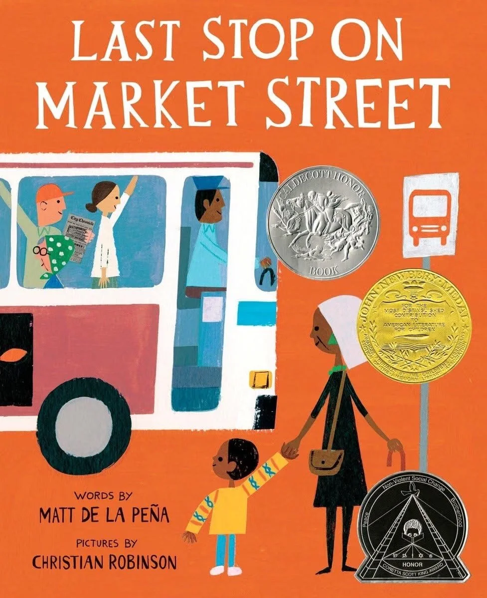 Cover of a book titled "Last Stop on Market Street" with illustrations of a woman and a child walking, and a bus with passengers. Includes two medals and a bus stop sign. Text credits Matt de la Peña as the author and Christian Robinson as the illustrator.