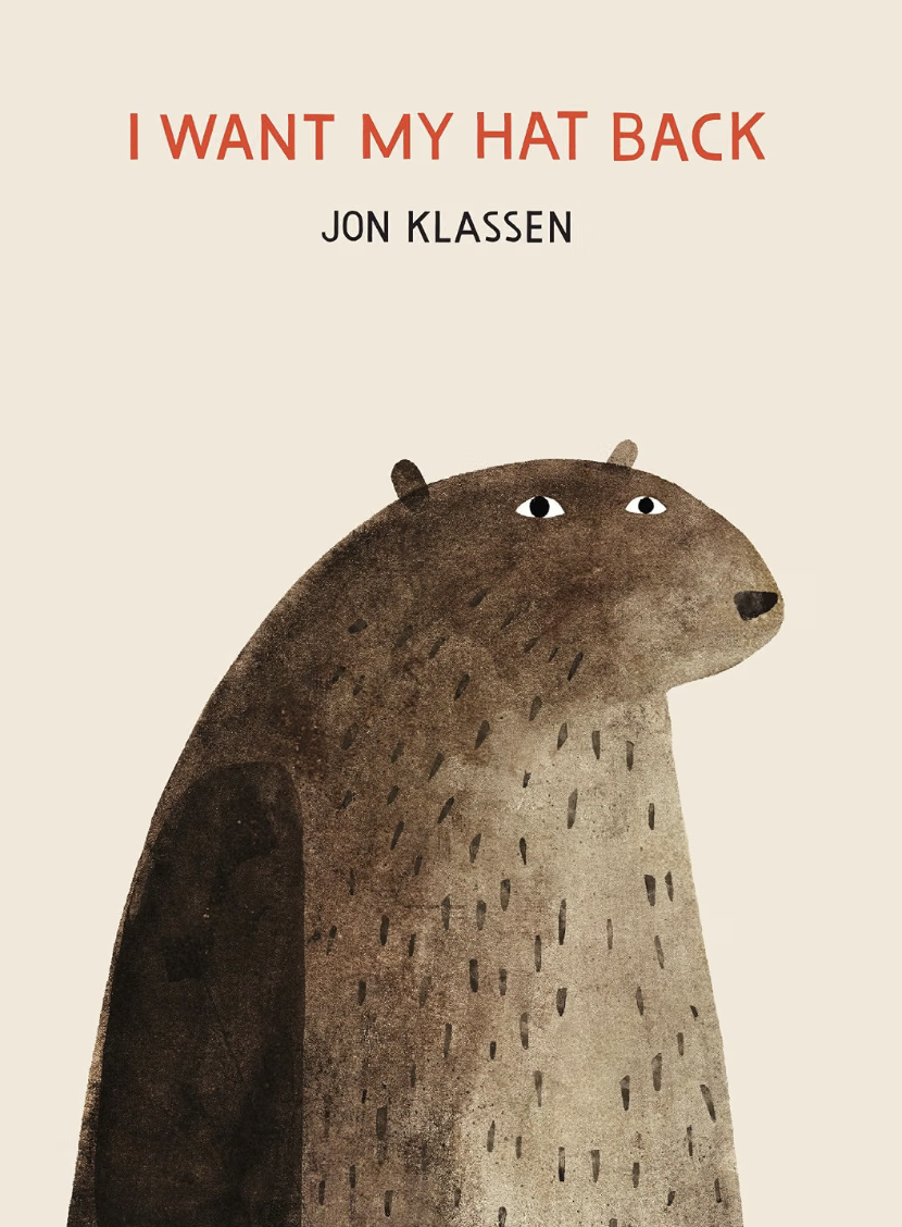 Book cover titled "I WANT MY HAT BACK" by Jon Klassen featuring an illustrated bear with three eyes on a plain background.