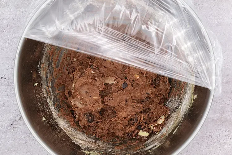 Cookie dough covered with plastic wrap for chilling