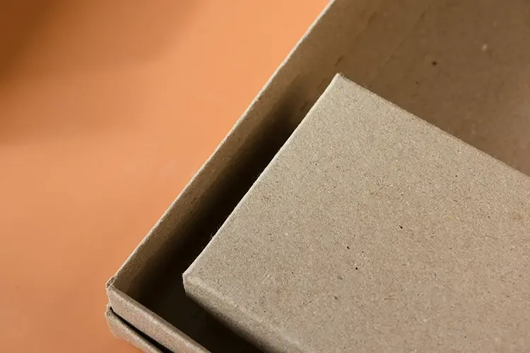 Two eco-friendly, sustainable boxes placed against an orange background.