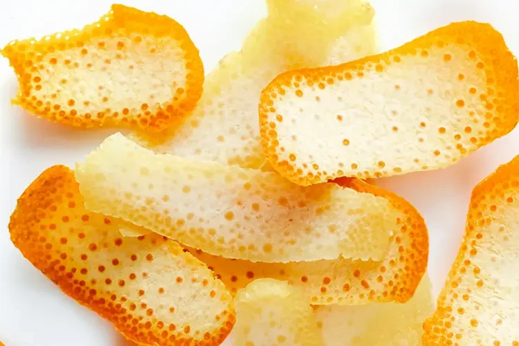Orange peel placed on a white background.