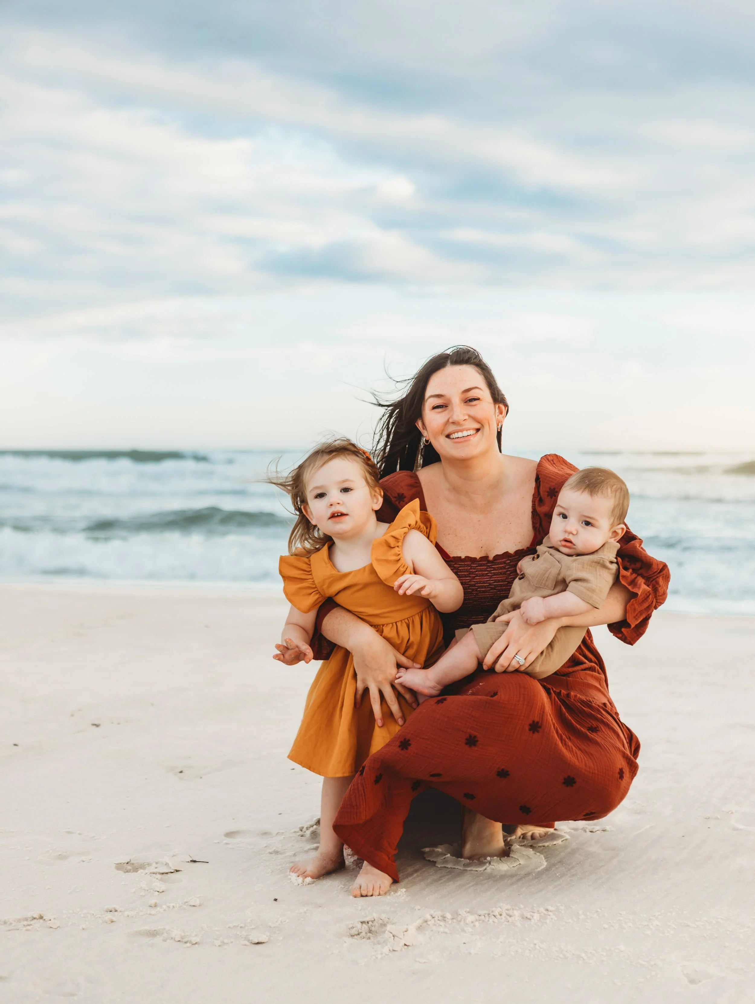 A tender motherhood moment on the sandy shores of Orange Beach. 
