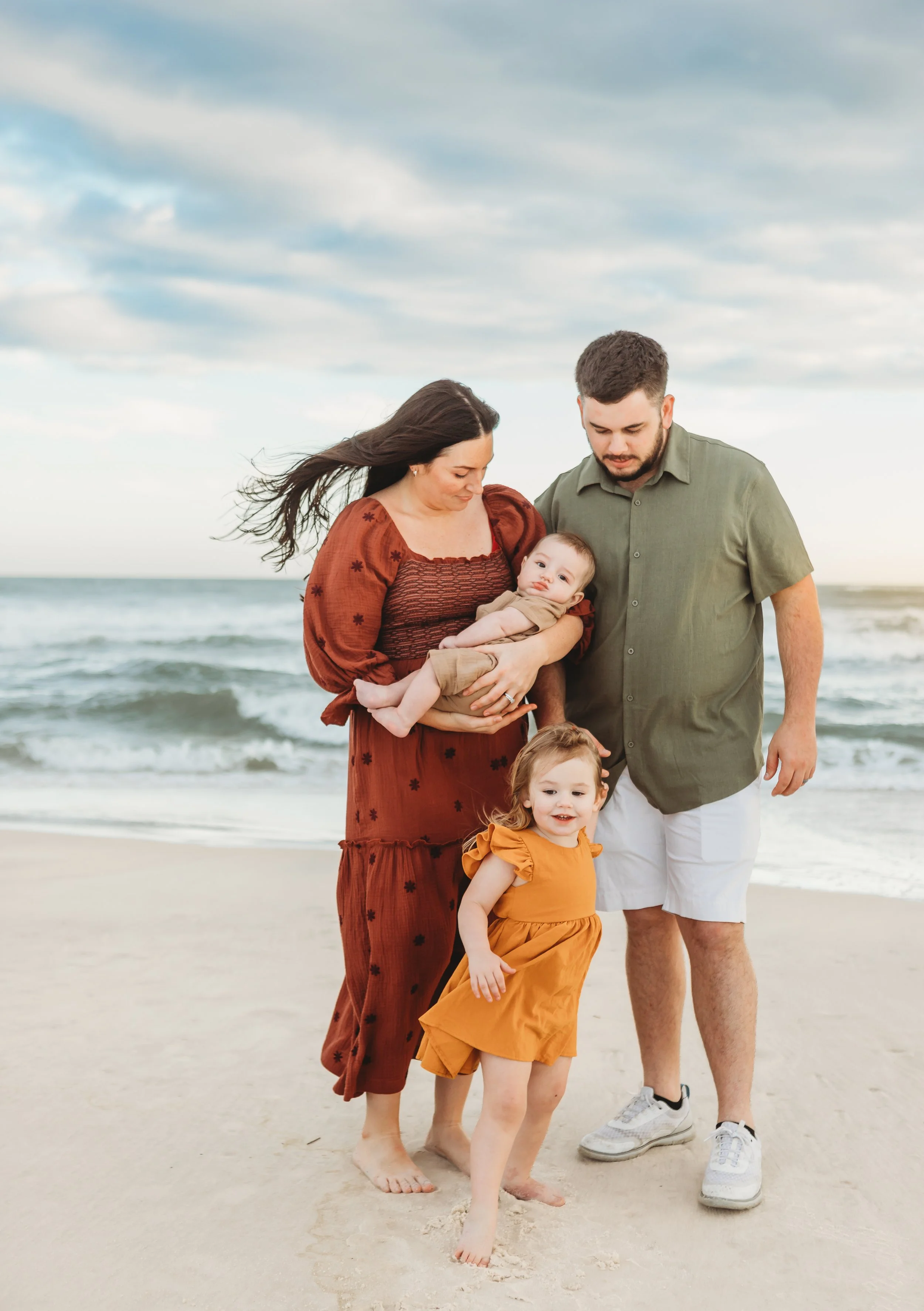 Family of four, mom and dad with their baby and toddler.