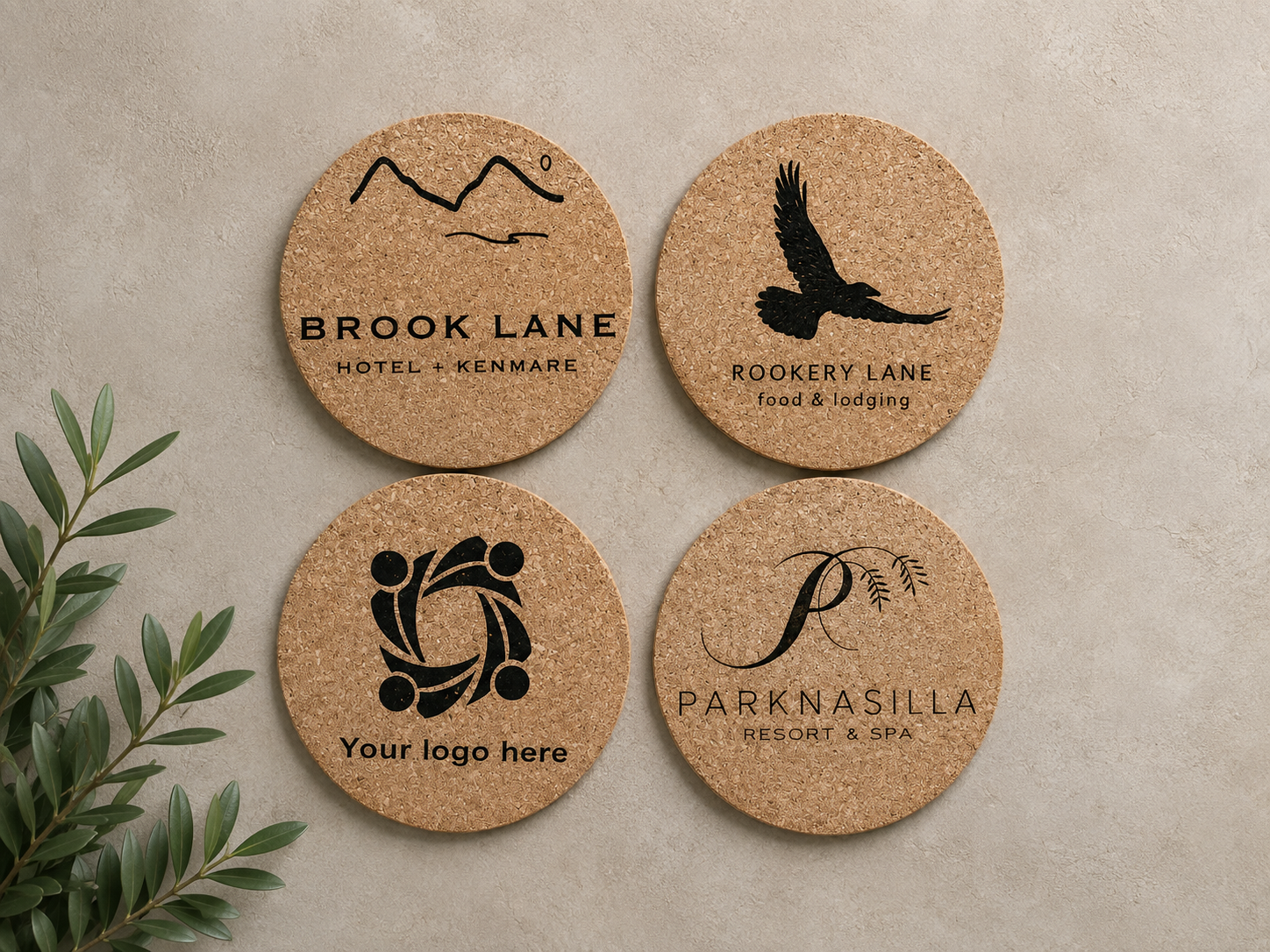 Four round cork signs with black graphics and text, mounted on a beige wall, with green plant leaves visible on the left.