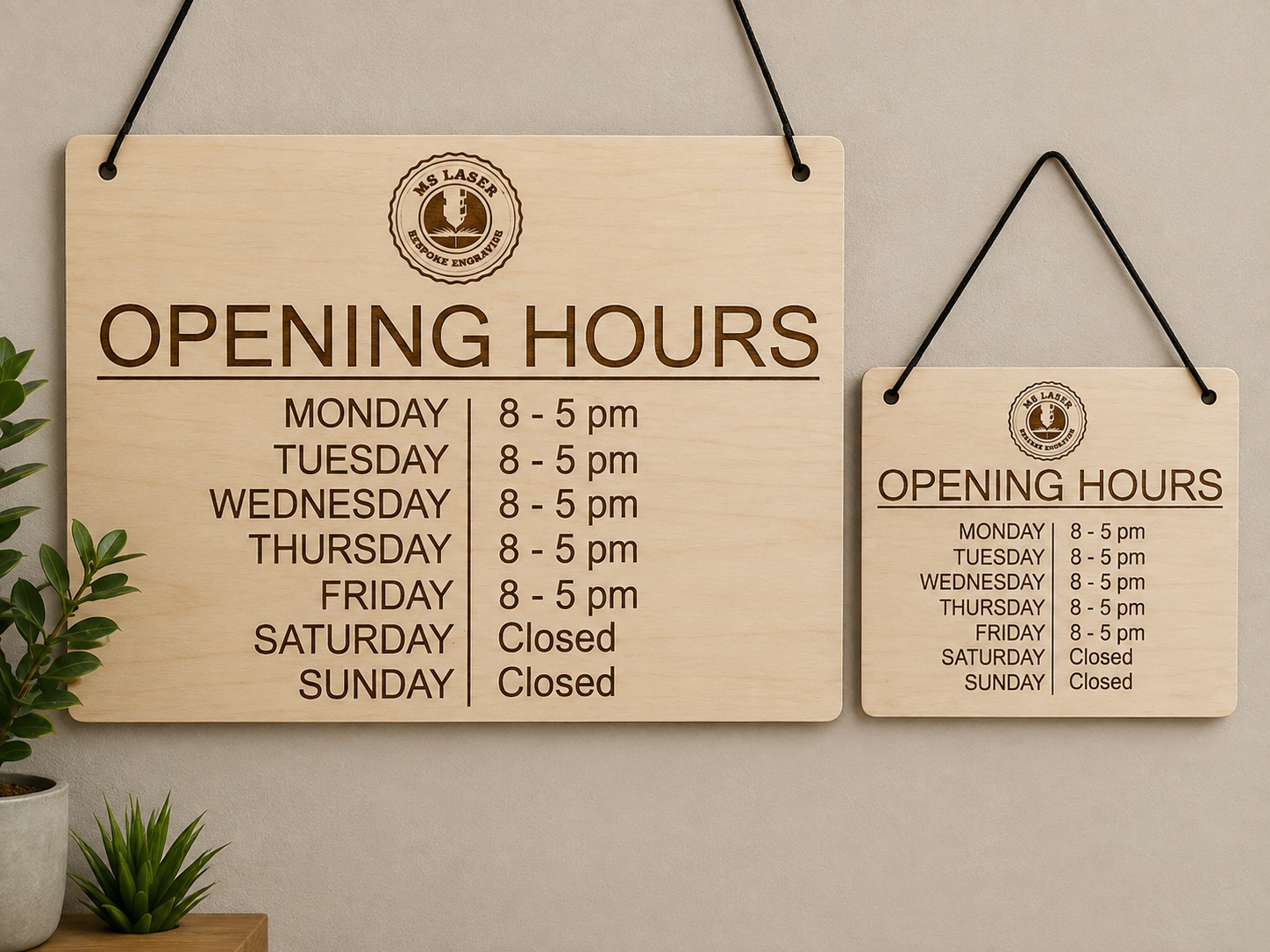 Two wooden signs displaying business hours. The larger sign shows Monday to Friday from 8 a.m. to 5 p.m., closed on Saturday and Sunday. The smaller sign repeats the same hours with additional days marked as closed.