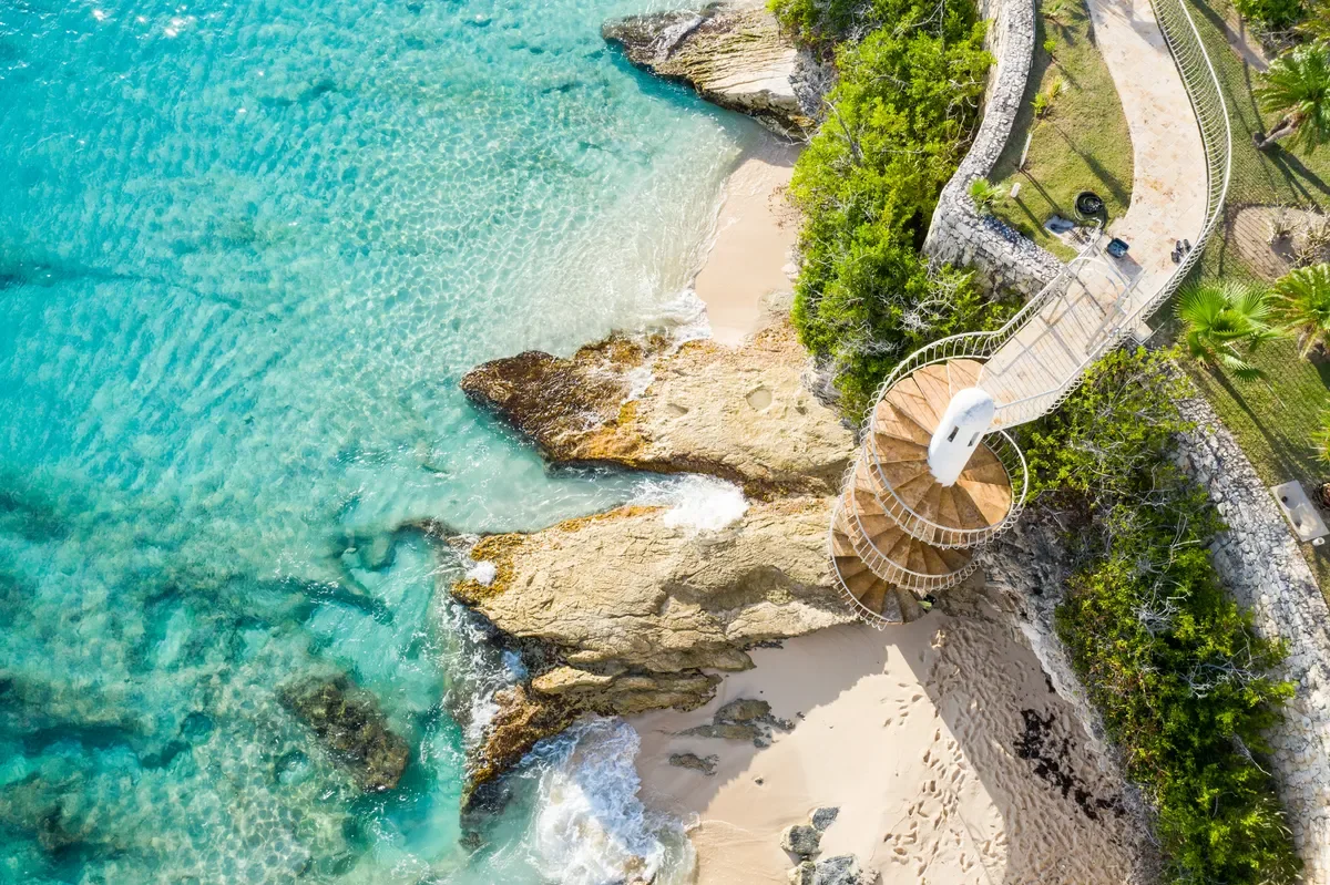 sintmaarten-staircase-rainbowbeachclub2-cupecoybeach CREDIT St. Maarten Tourism Bureau.webp