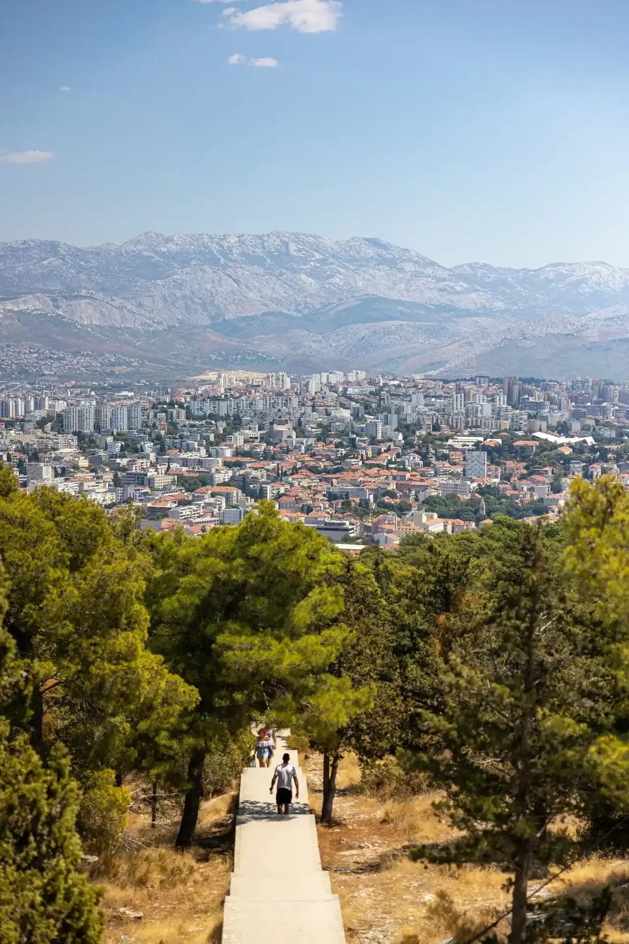 Panoramic view of Split, Croatia, with the city below, surrounding hills, and Mount Mosor in the background.