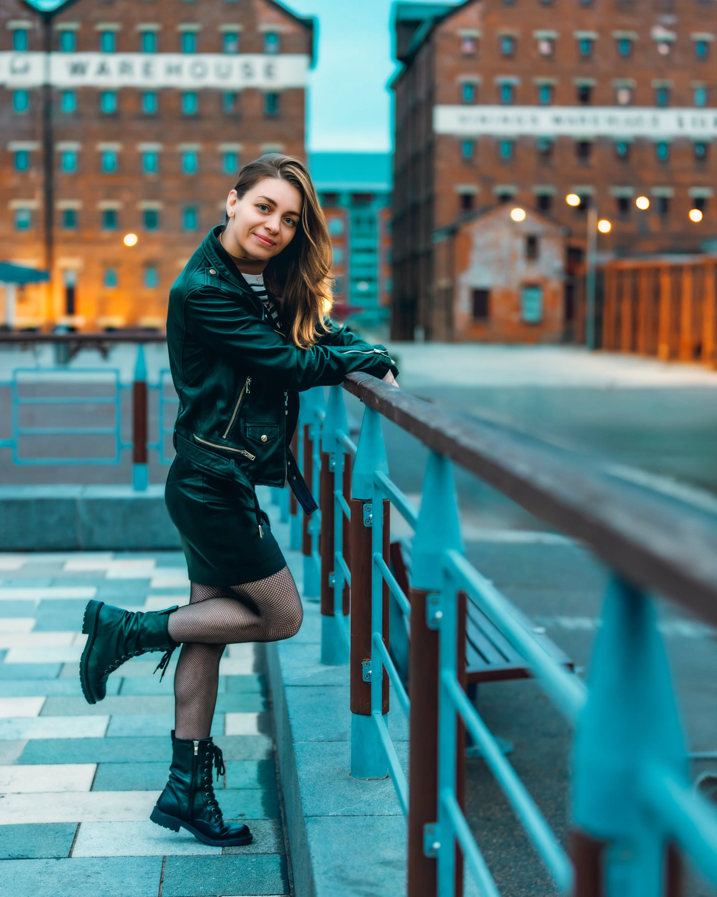 Blue hour portrait of a young girl dressed in a leather skirt and leather jacket at the Gloucester quays 