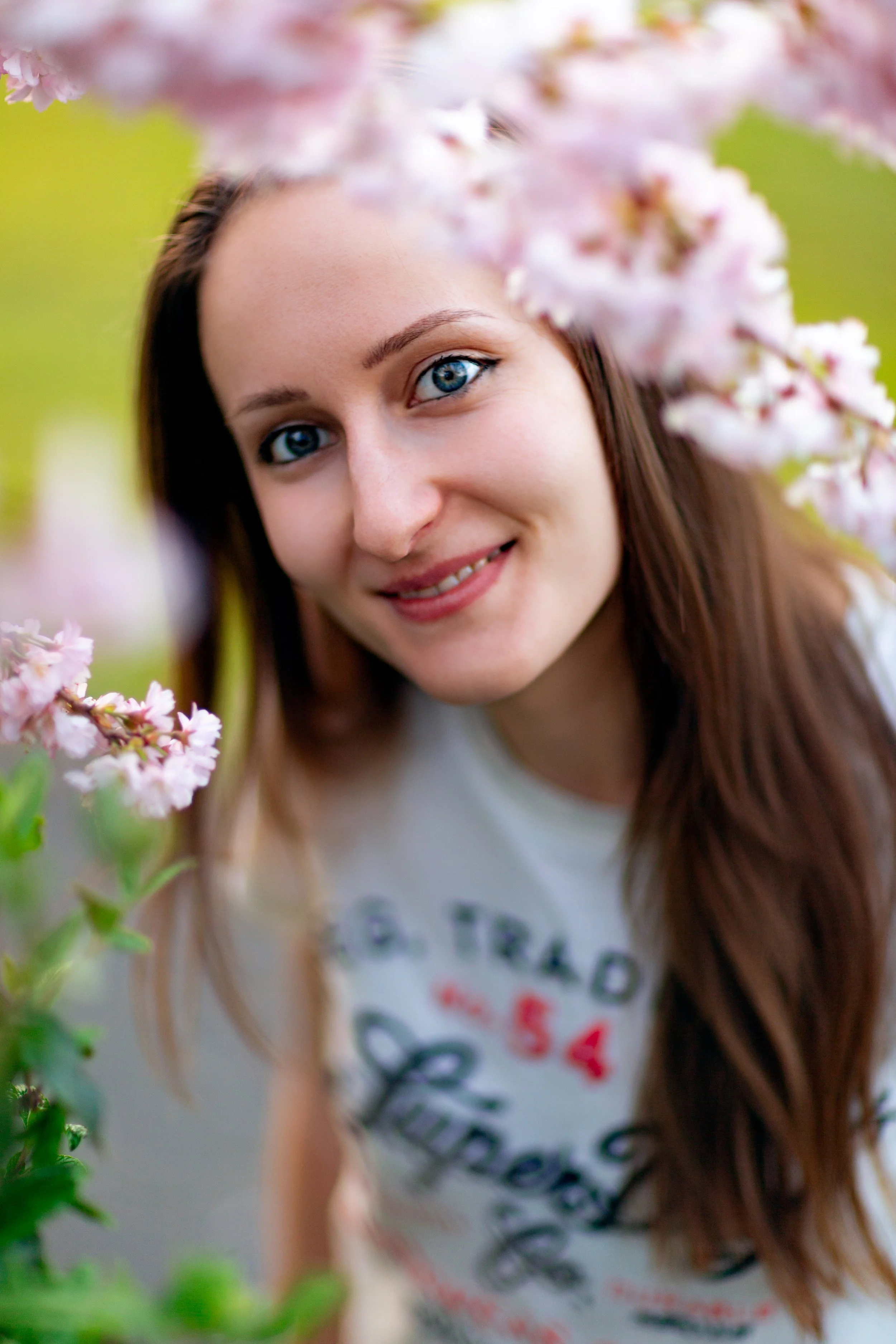 Portrait of a woman through a blooming cherry tree
