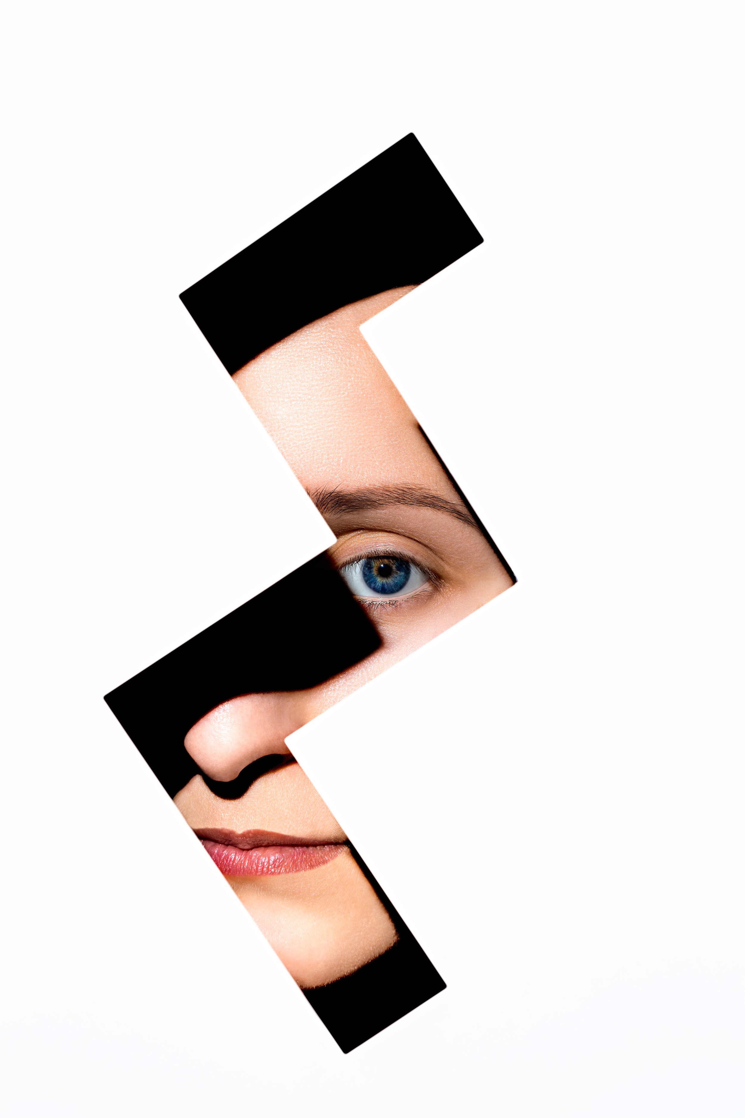 Conceptional photograph of a woman behind a cutout 