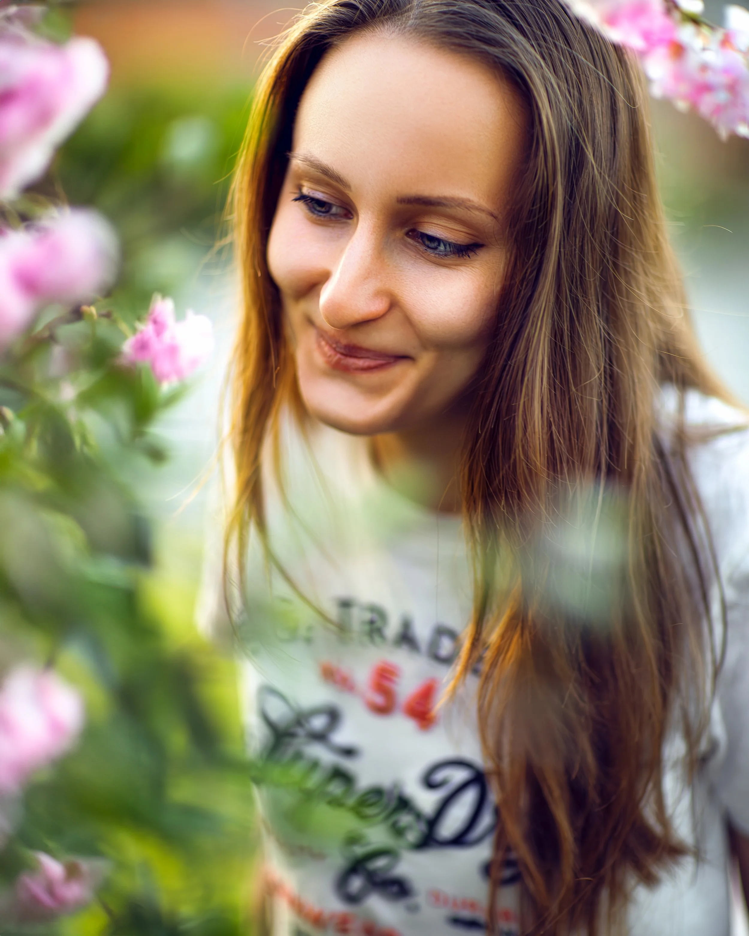 Portrait of a woman through a blooming cherry tree