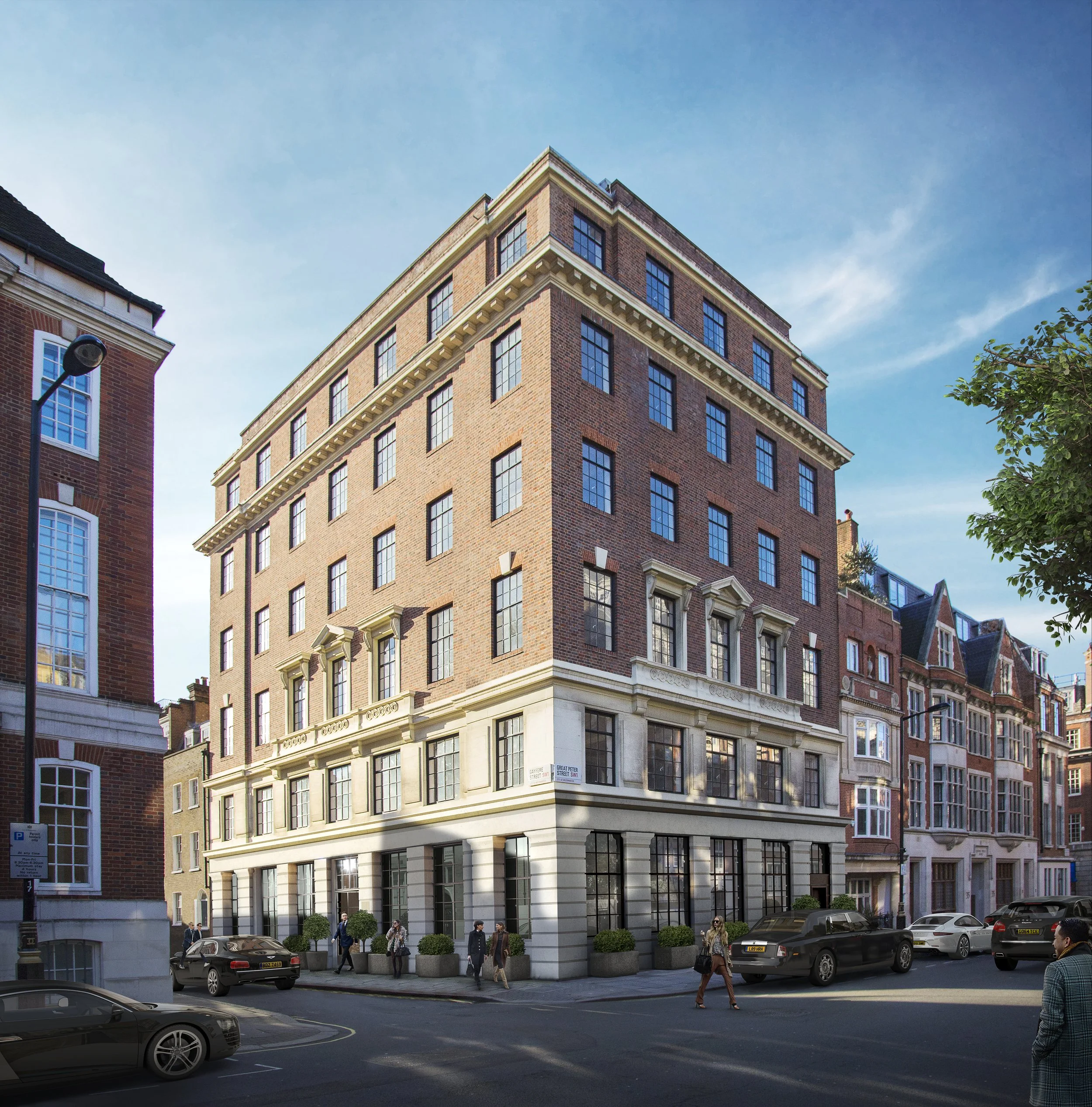 A city street corner with a multi-story brick building and pedestrians walking by.