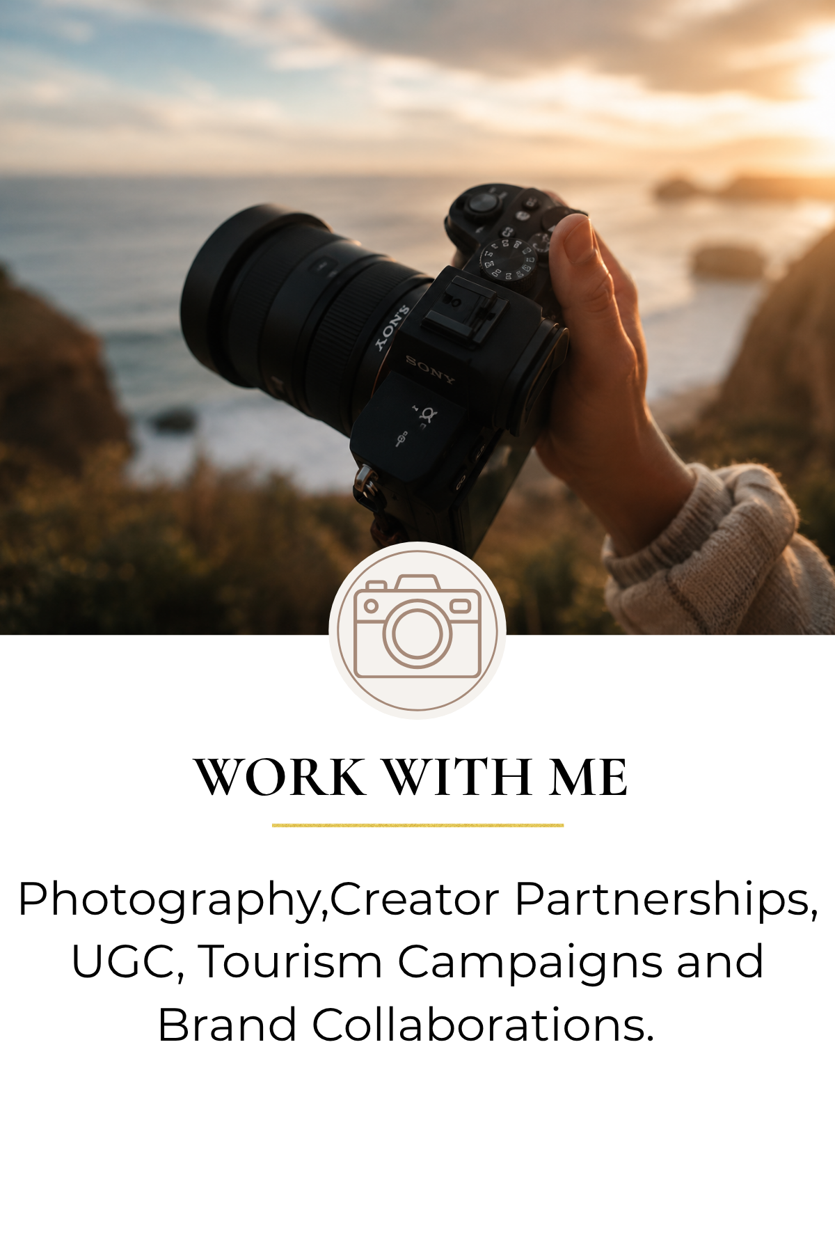 A person holding a camera outdoors during sunset, with the ocean and cliffs in the background.