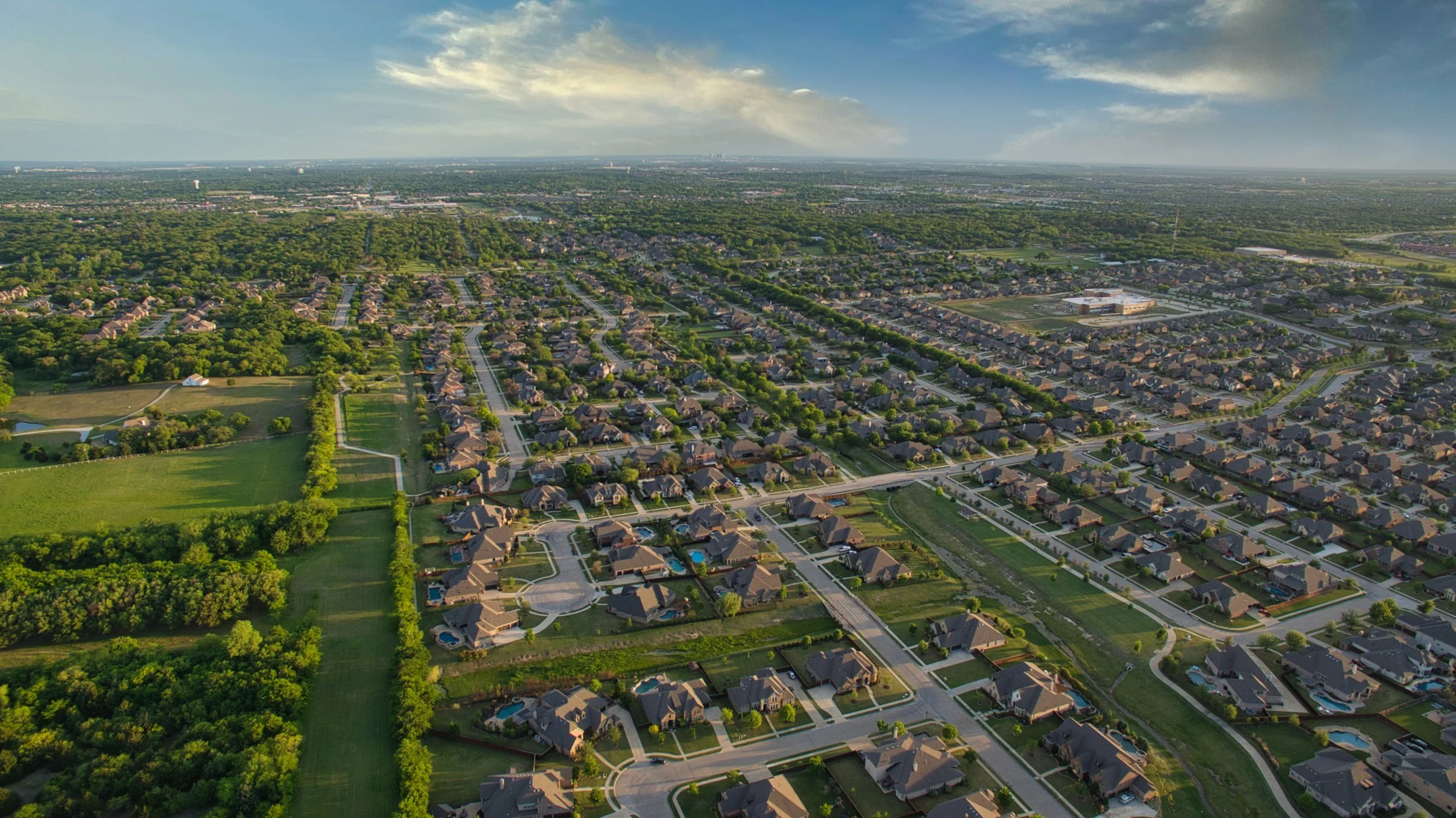 Aerial view of a large residential community and surrounding real estate development