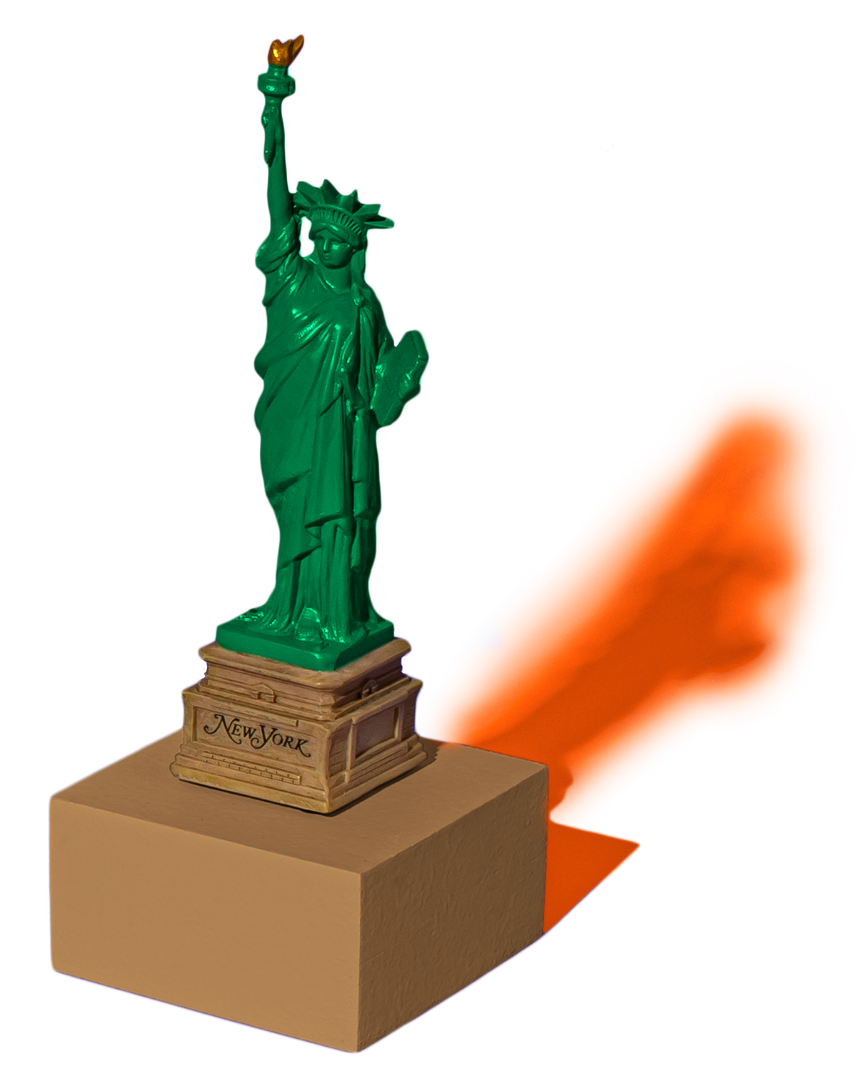 Green Statue of Liberty figurine on a brown base labeled 'New York,' with green and orange shadows on a purple background.