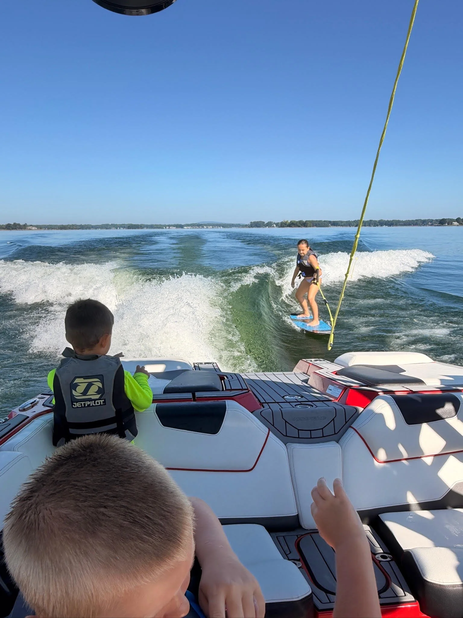 Young man jumping on a wakeboard at Lake Norman