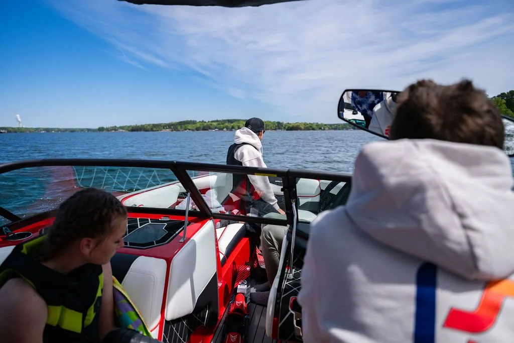 Group of students riding in a boat on Lake Norman in between water sport lessons