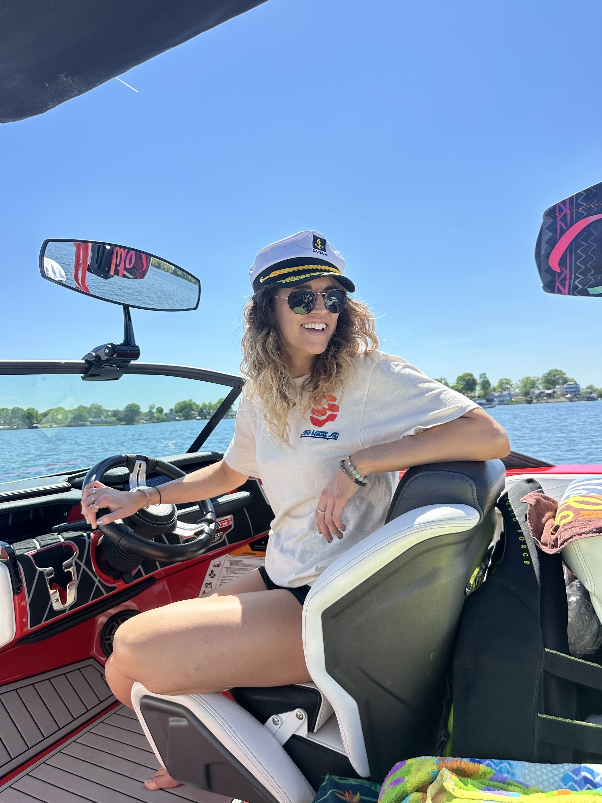 Captain Audrey driving a water sport boat for Surf Wake Ski on Lake Norman, NC.