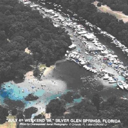 Aerial view of Silver Glen Springs with many boats gathered along the shoreline