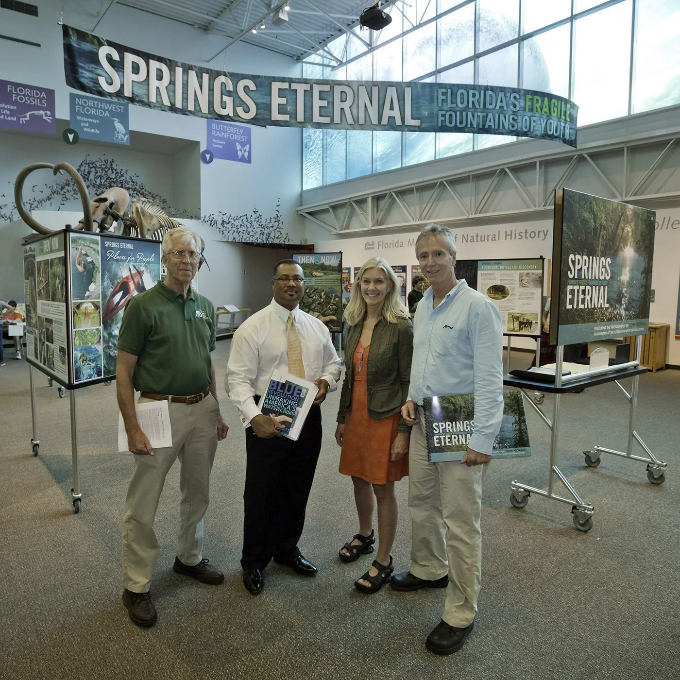 Group of people standing inside a museum exhibit about Florida springs