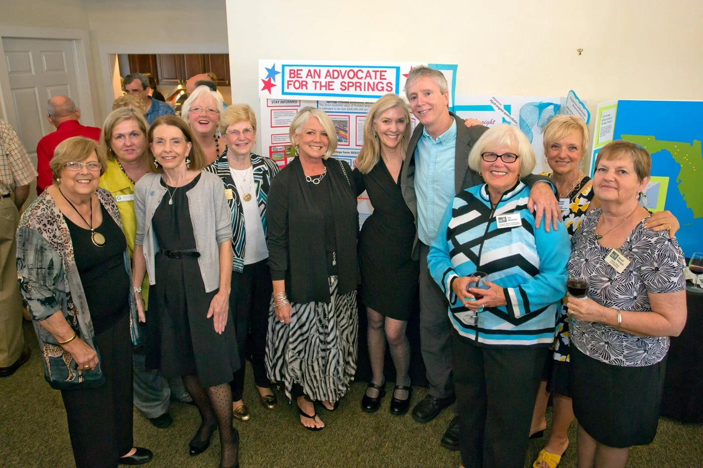 Group of community members gathered at a “Be an Advocate for the Springs” display during a Springs Eternal Project event.