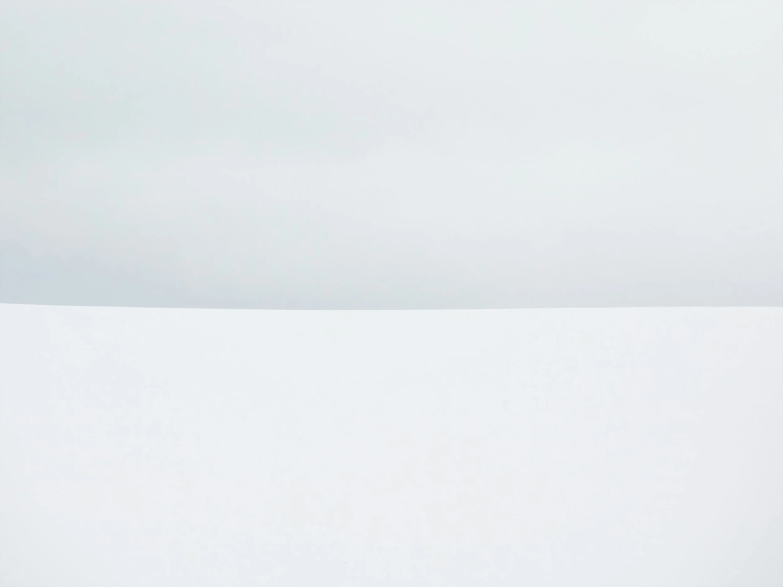 Plain white and light gray abstract background with smooth gradient.