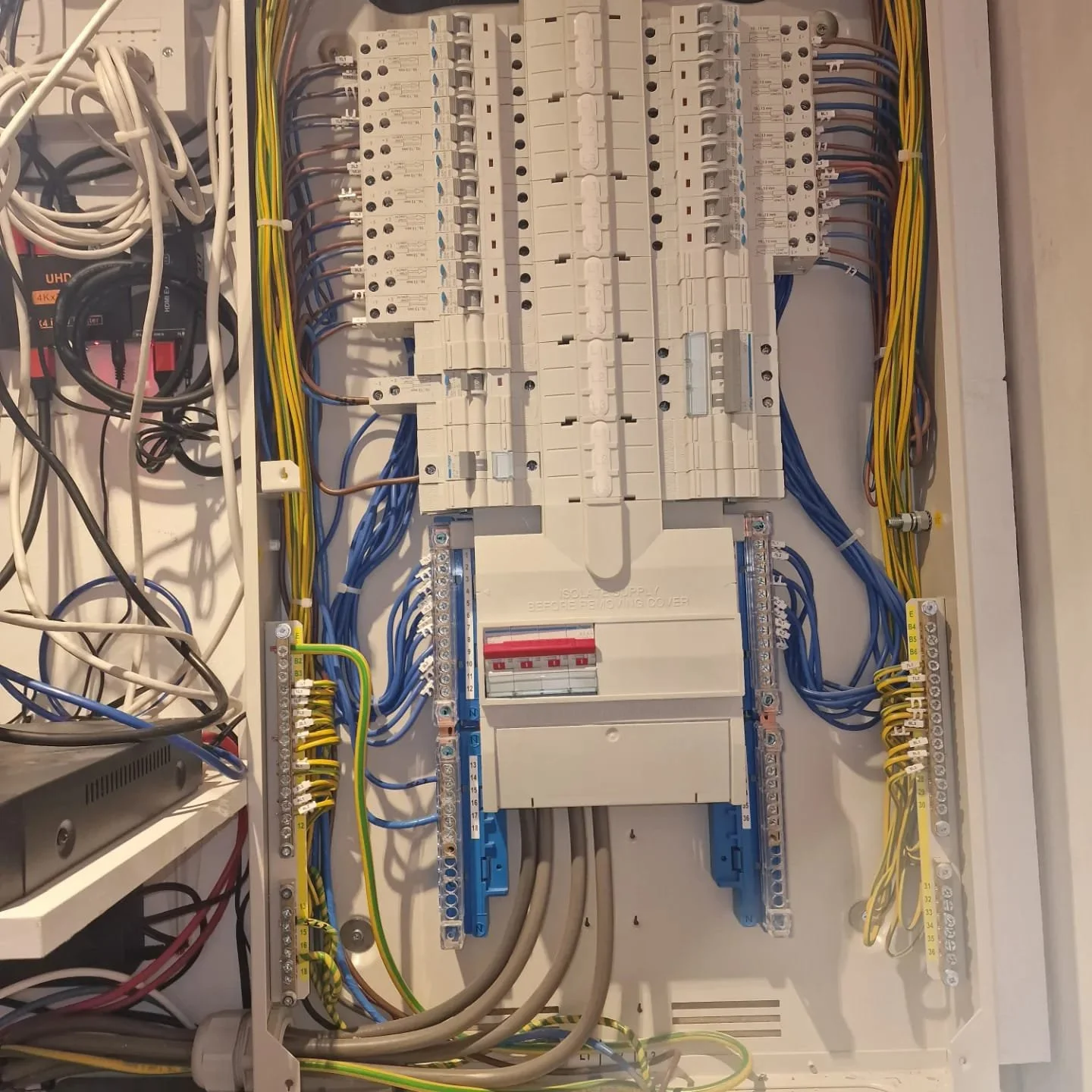 Electrical circuit breaker box containing circuit breakers, wiring, and electrical components.