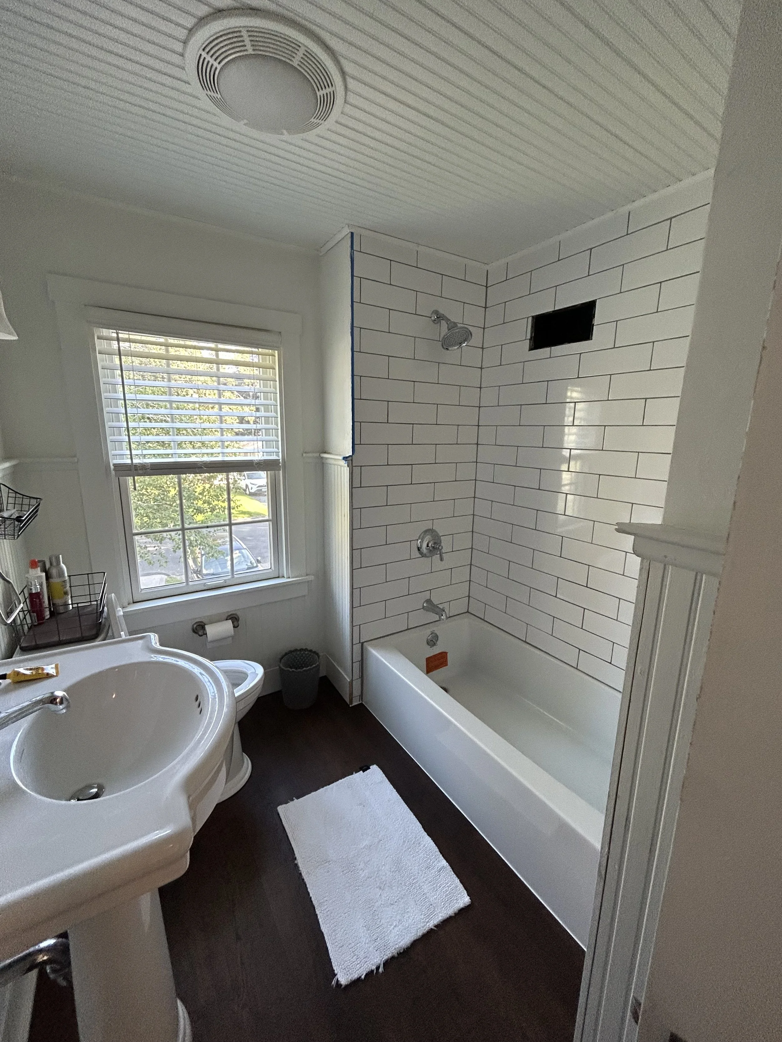 Bathroom with Subway tile, Bathtub, LVP floors, chrome fixtures