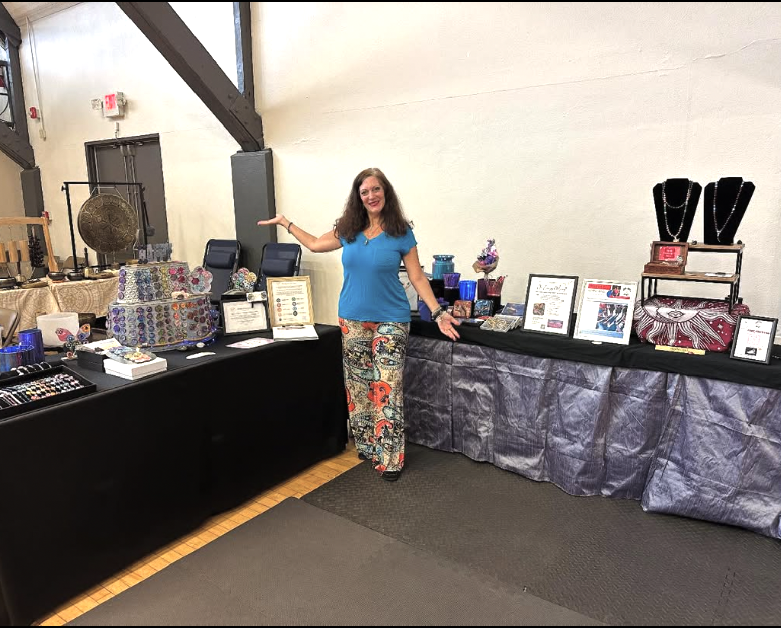 full length photo of nancy abramson in front of her a happy place with nancy booth at an artisan market