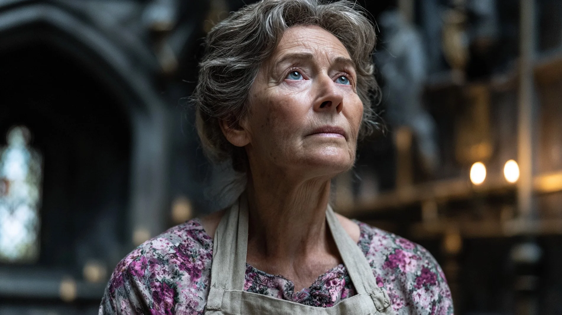 An elderly woman with gray, curly hair looking up thoughtfully, wearing a floral blouse and an apron, in a dimly lit kitchen or workshop.
Combine genres with the click of a button!