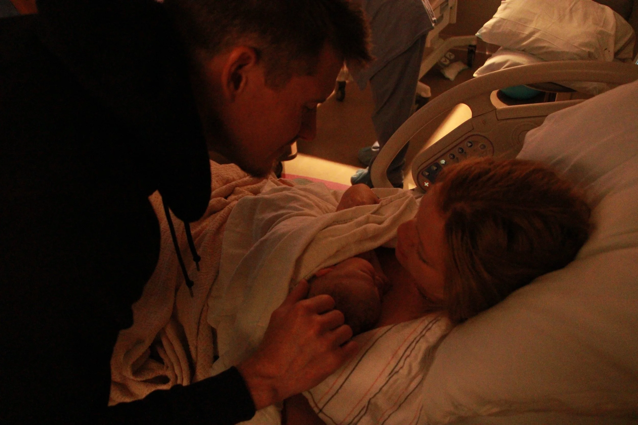 Medical team assisting with childbirth in a hospital delivery room.