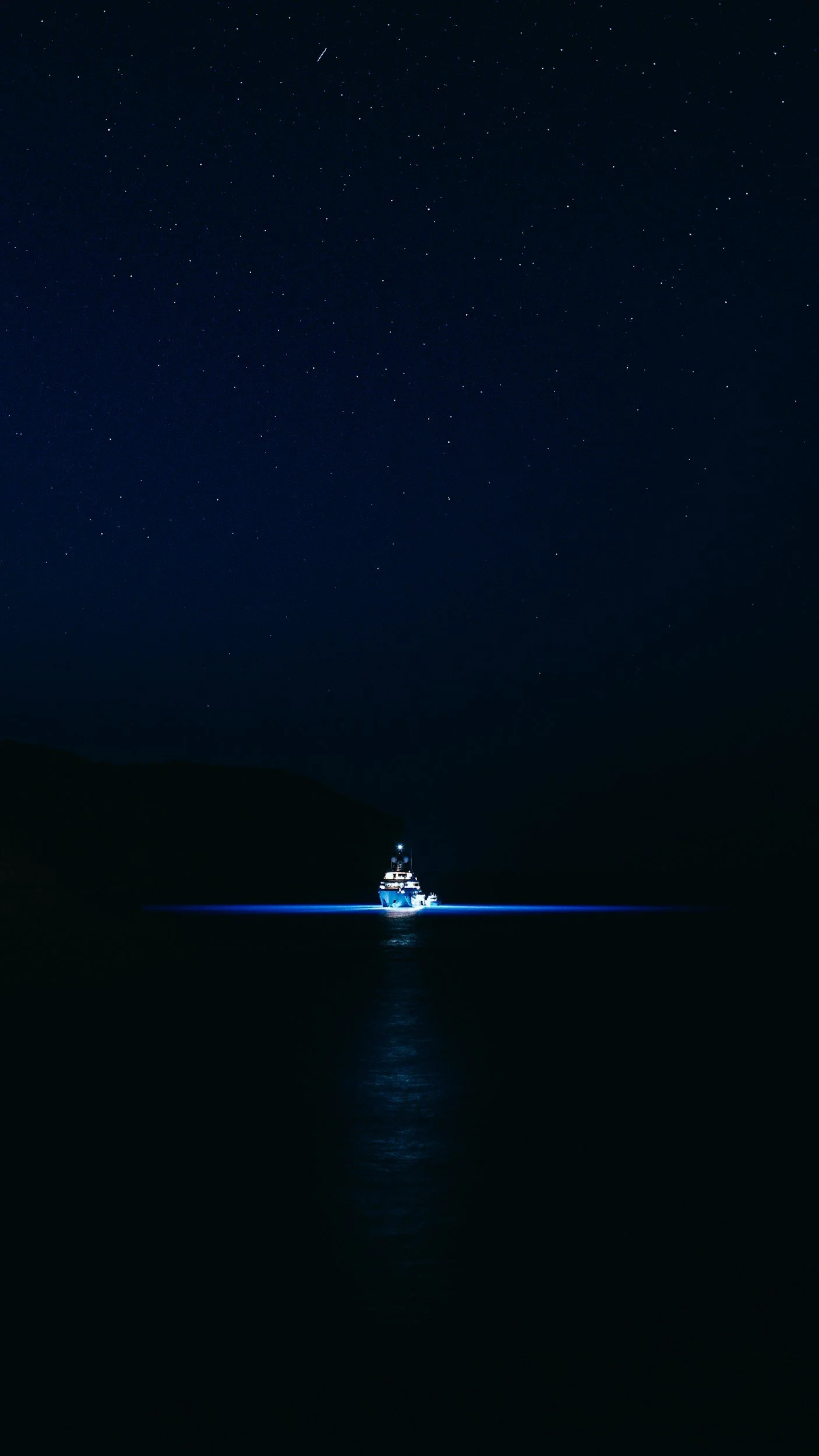 A boat illuminated at night under a starry sky, with reflections on the water. Representing how NorthStar Marketing can help guide your business growth.