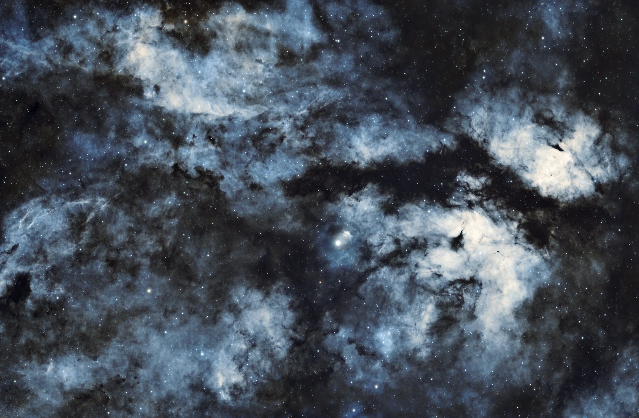 A detailed view of a star-filled galaxy with bright and dark nebulae, showcasing the vast and colorful expanse of outer space.