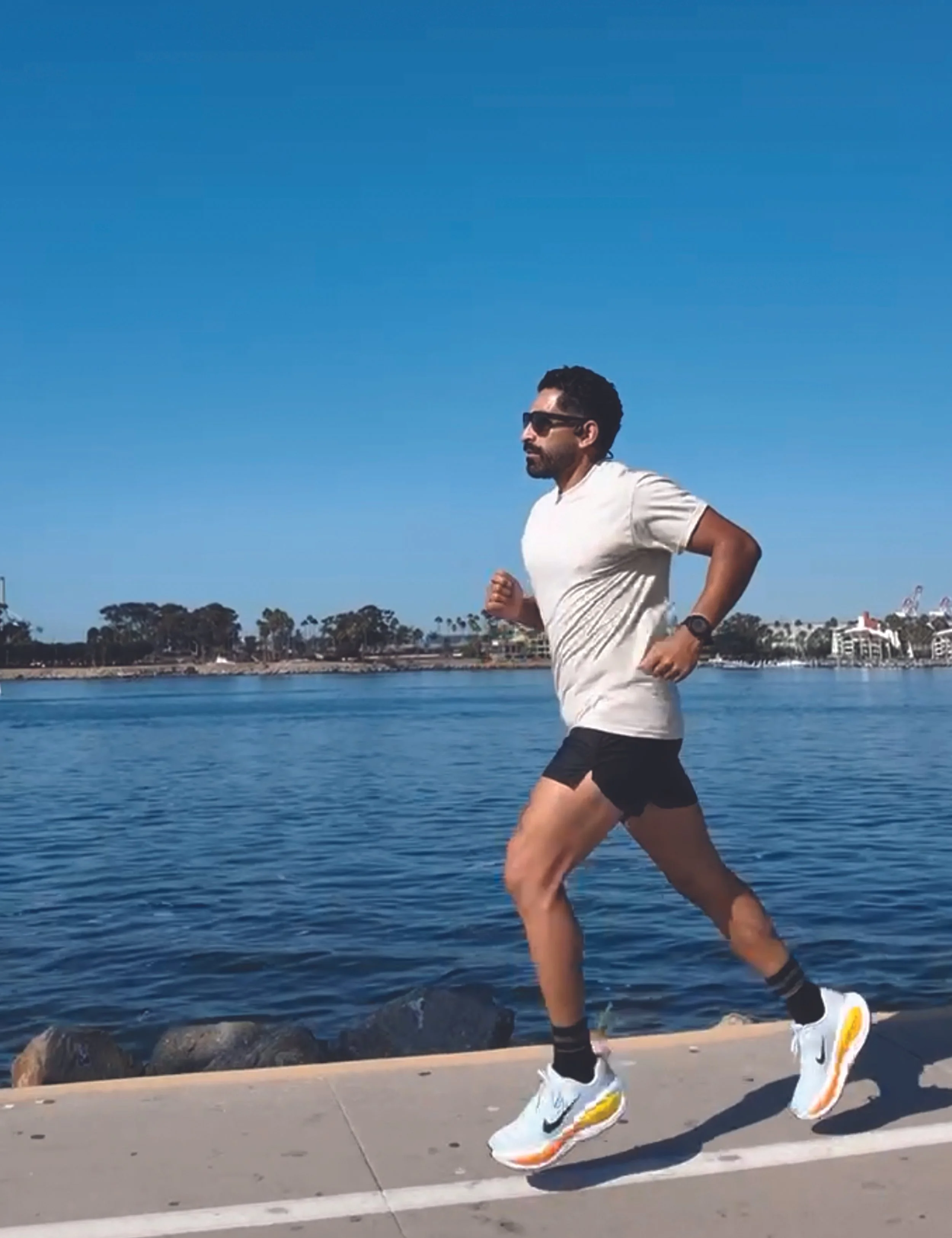 Run Wild Roam Free Unisex T shirt - on model while running along the Long Beach Bike Path