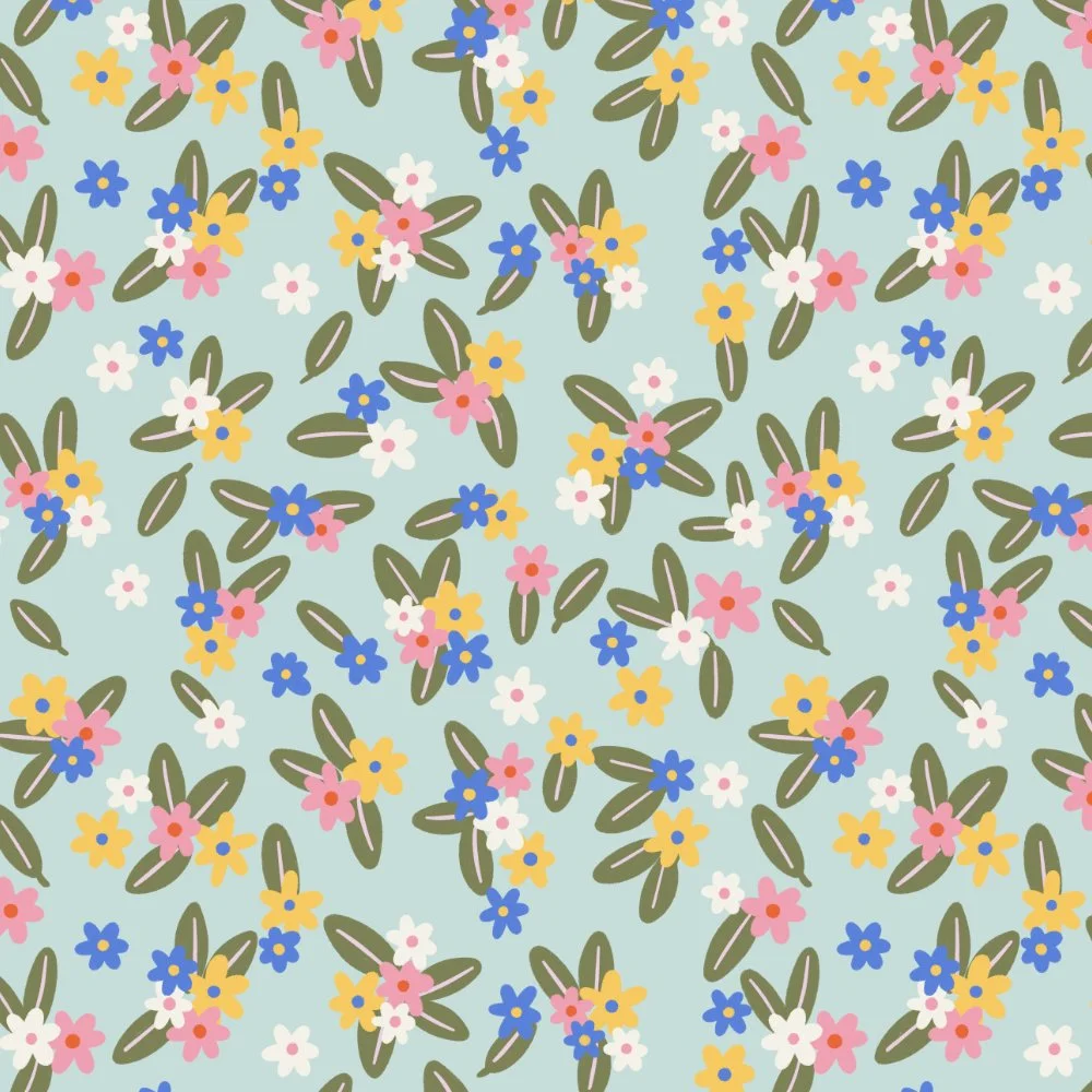 A pattern of small colorful flowers and green leaves on a light blue background.