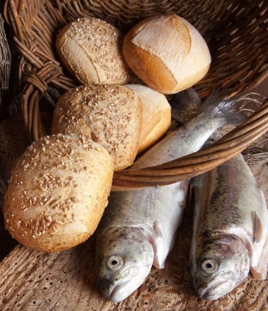 Basket with assorted bread rolls and two fresh fish